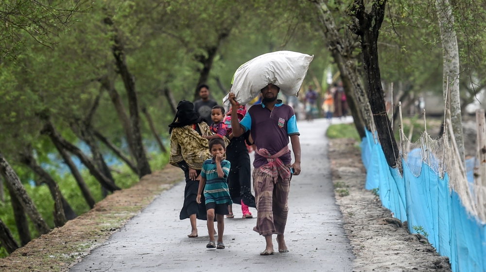 Residents walk along a street heading to a shelter ahead of the expected landfall of cyclone Amphan, in Dacope of Khulna district on May 20, 2020. Several million people were taking shelter and prayin