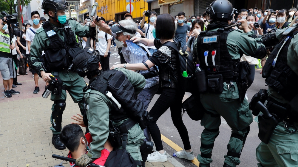 Hong Kong anti-government demonstrators scuffle with riot police