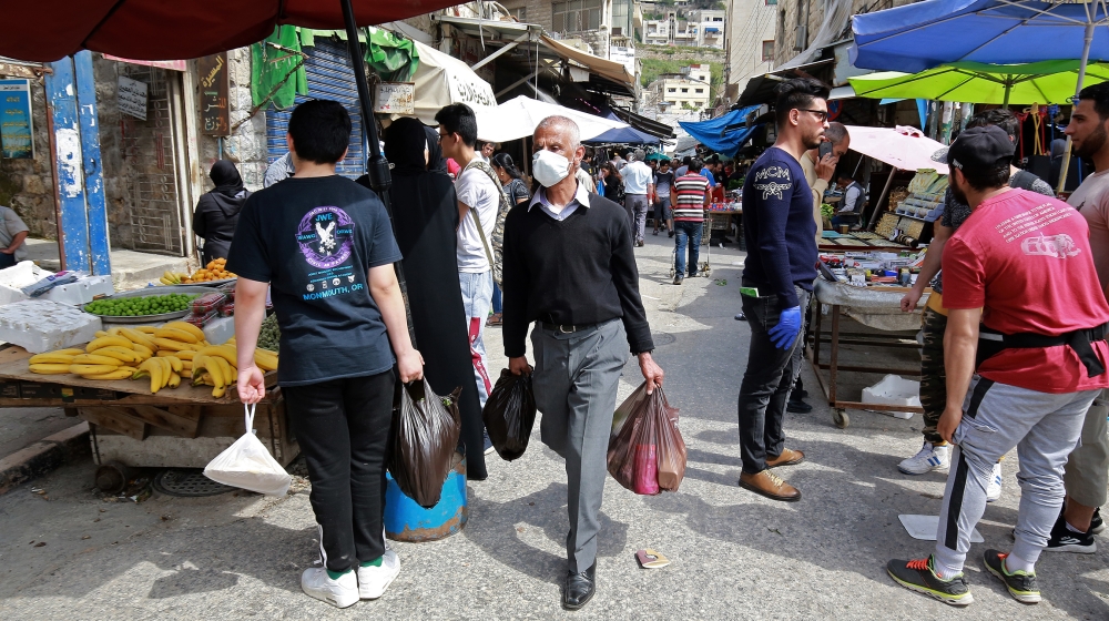 Residents shop at a market during the novel coronavirus pandemic crisis in the Jordanian capital Amman Khalil MAZRAAWI / AFP