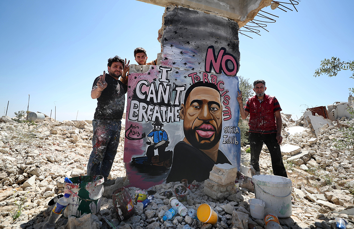 Syrian artists Aziz Asmar and Anis Hamdoun finish a mural depicting George Floyd, an unarmed African-American man who died while while being arrested and pinned to the ground by the knee of a Minneapo