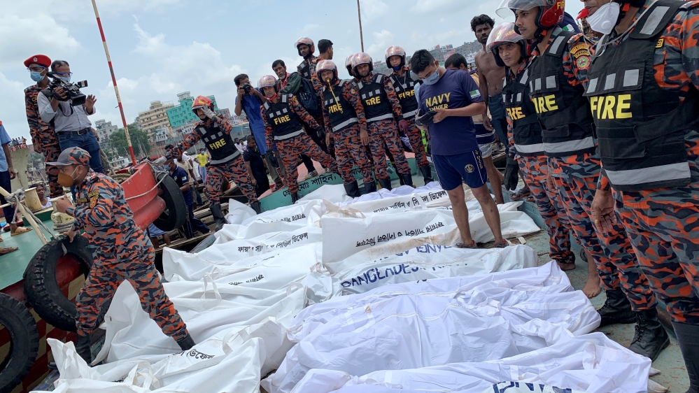 Dead bodies are seen piles up on a boat after a passenger ferry capsized in the river Buriganga in Dhaka
