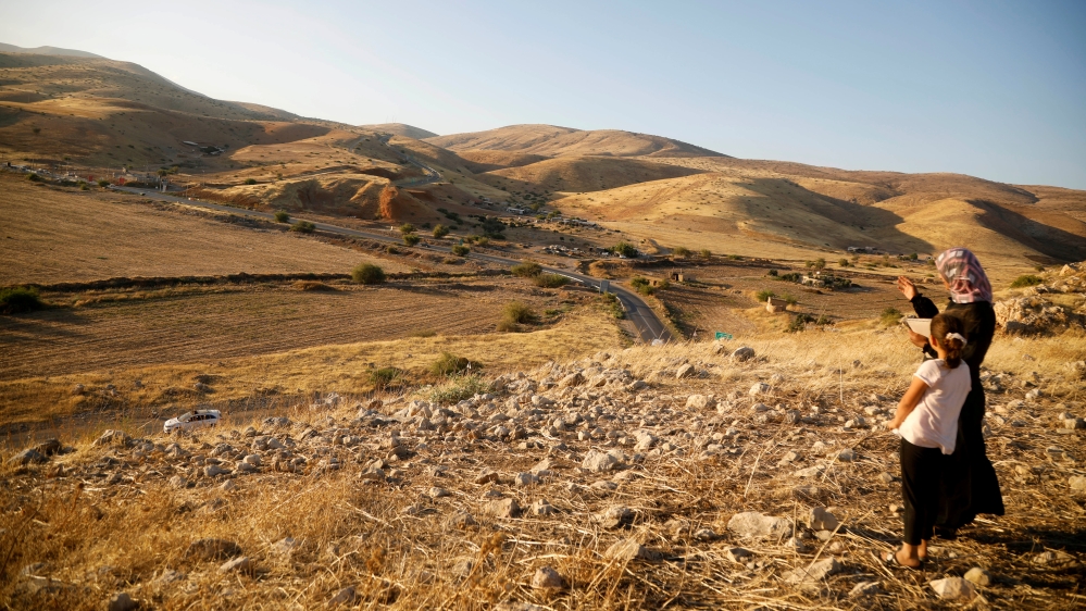 Khadeeja Bisharat, a Palestinian artist, stands with her daughter Remas in Jordan Valley in the Israeli-occupied West Bank