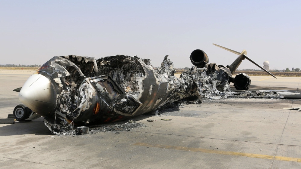 A wreckage of a burnt aircraft is pictured after a shelling at Tripoli International Airport