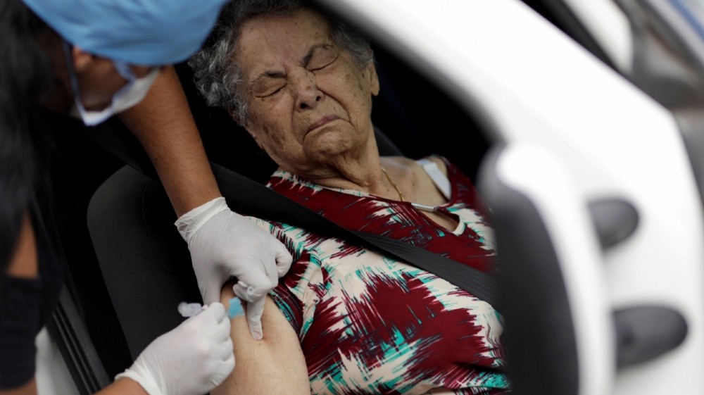 A health worker vaccinates a woman against the flu, as advised by health officials to facilitate diagnosis for coronavirus, amid the coronavirus disease (COVID-19) outbreak