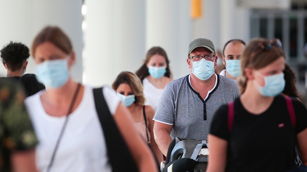Passengers wearing face masks arrive at Son Sant Joan airport on the Spanish Balearic Island of Mallorca, Spain