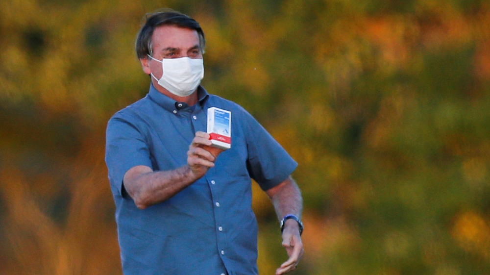 Brazil”s President Jair Bolsonaro holds a box of chloroquine outside of the Alvorada Palace, amid the coronavirus disease (COVID-19) outbreak in Brasilia, Brazil, July 23, 2020.REUTERS/Adriano Machado TPX IMAGES OF THE DAY
