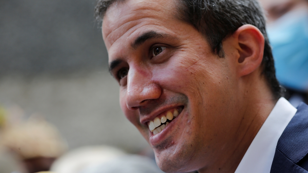 Venezuelan opposition leader Juan Guaido takes part in a news conference after Venezuela's pro-government supreme court replaced the leaders of two key opposition parties