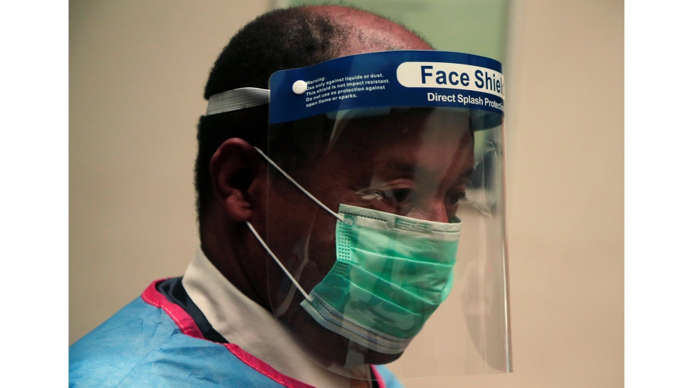 Zimbabwean health minister Obediah Moyo wears Personal Protective Equipment (PPE) during a visit to a hospital in Harare, Zimbabwe, March 5, 2020. REUTERS/Philimon Bulawayo