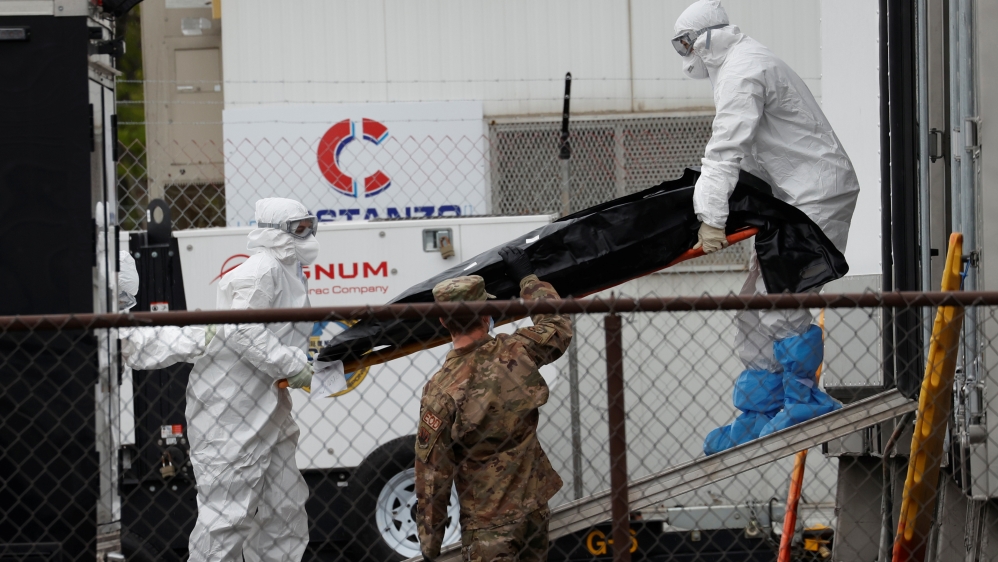 Workers move body of deceased person at University Hospital during outbreak of the coronavirus disease (COVID-19) in Newark