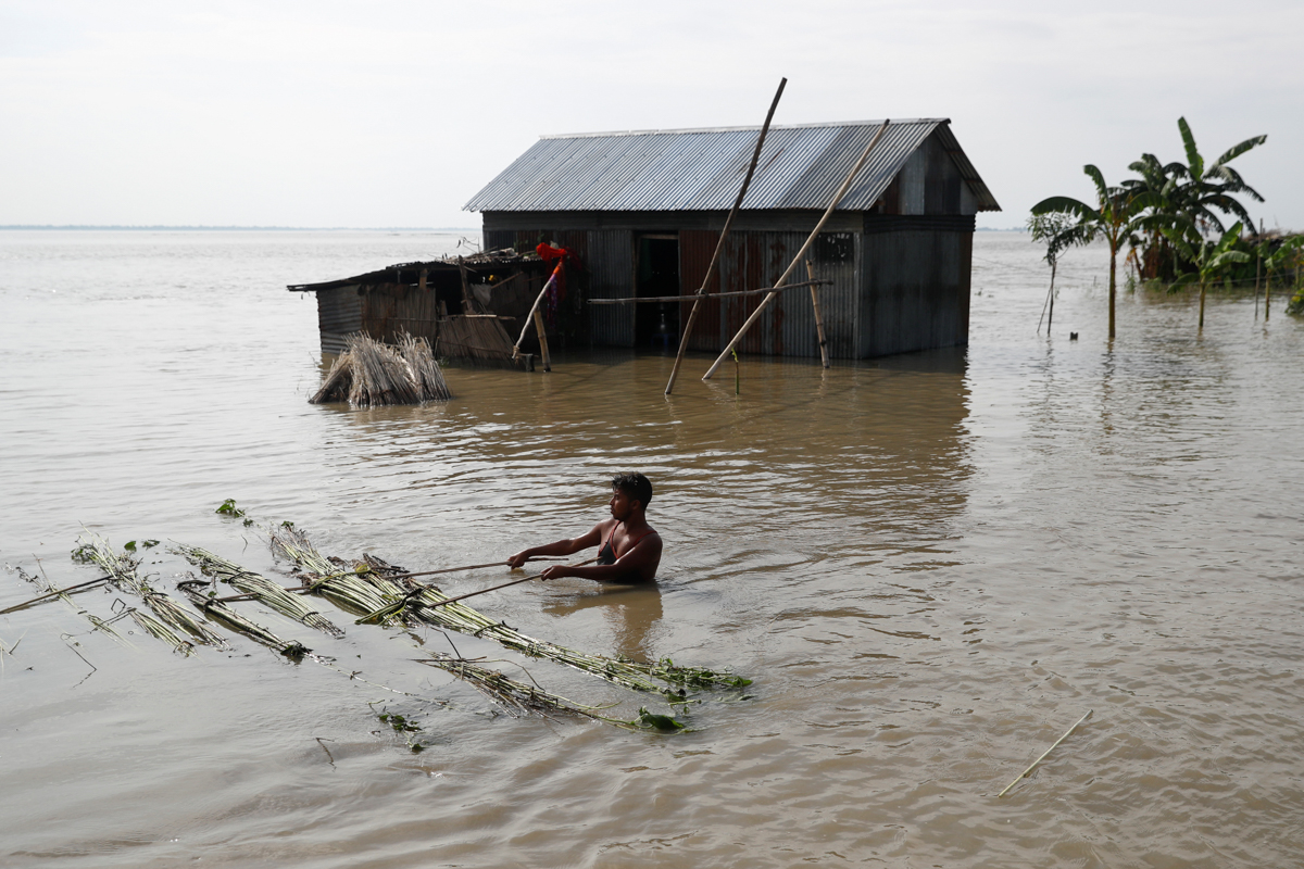 A flood-affected man moves jute plants to process in Jamalpur, Bangladesh, July 18, 2020. REUTERS/Mohammad Ponir Hossain