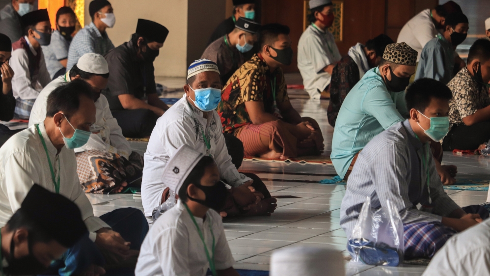 People attend Eid al-Adha prayer by implementing social distancing and health protocol during coronavirus outbreak at Al Akbar Mosque in Surabaya, East Java, Indonesia