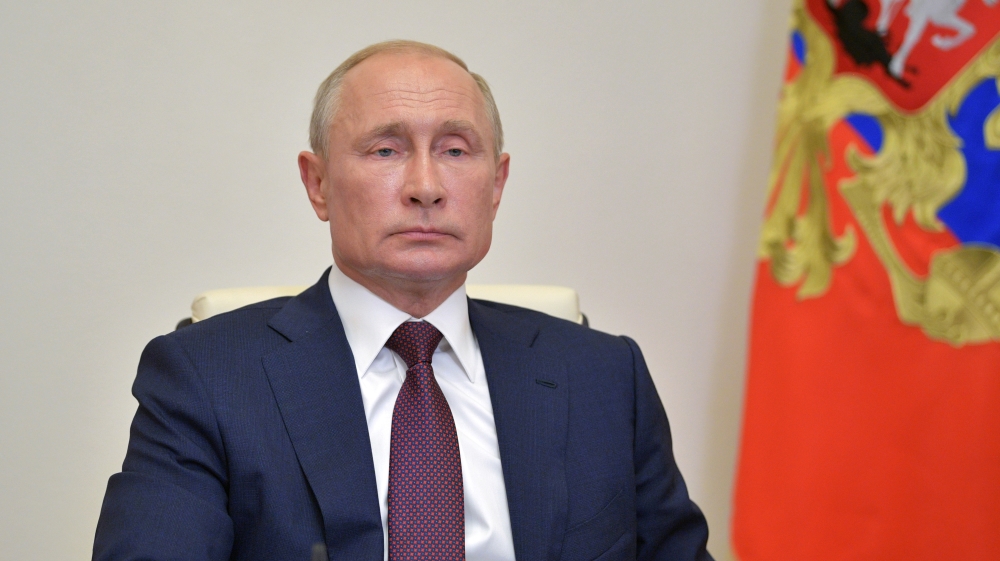 Russian President Vladimir Putin takes part in a a video conference call outside Moscow