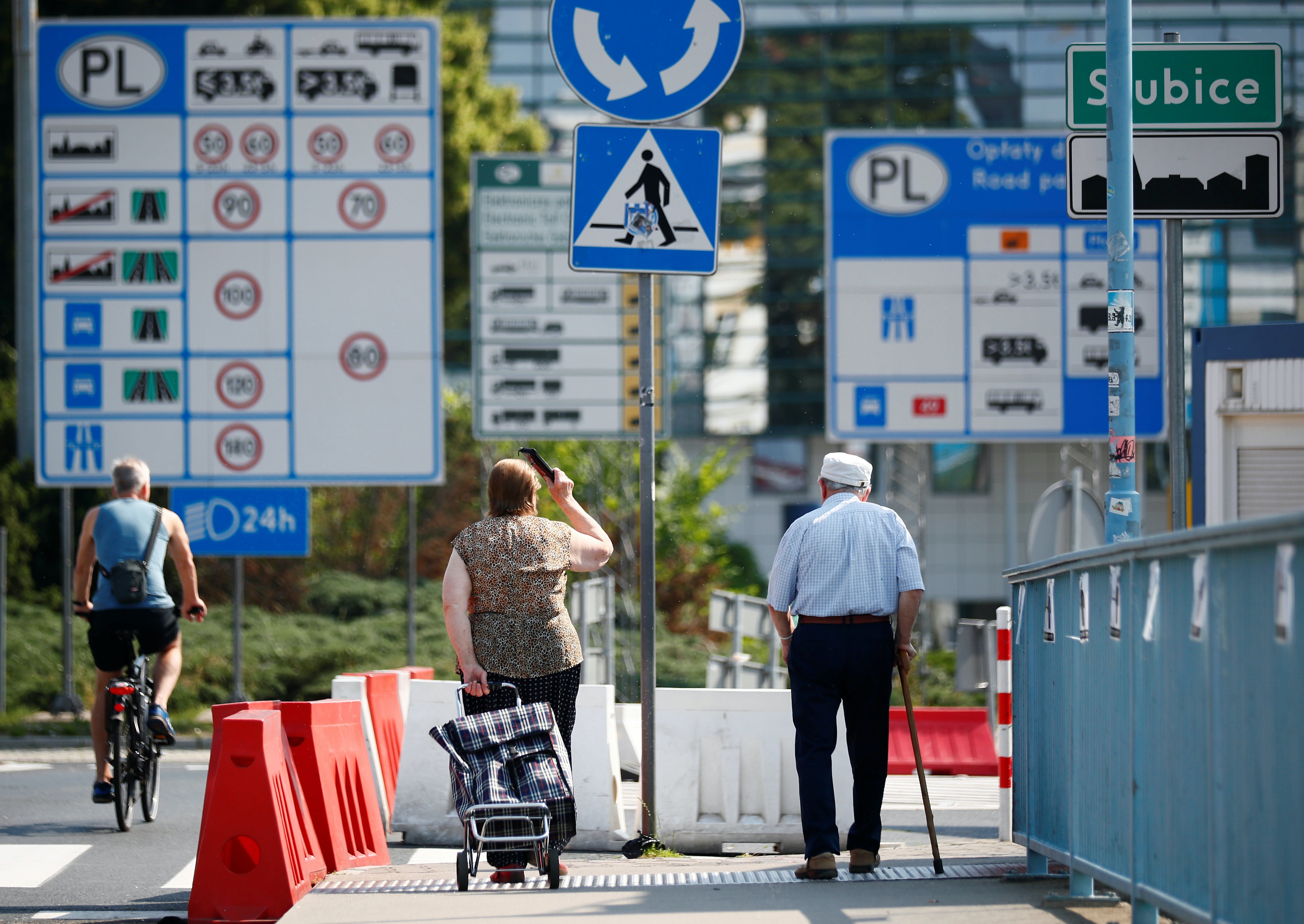 People cross the city bridge between Frankfurt (Oder) and Slubice, after Poland reopened borders with European Union countries