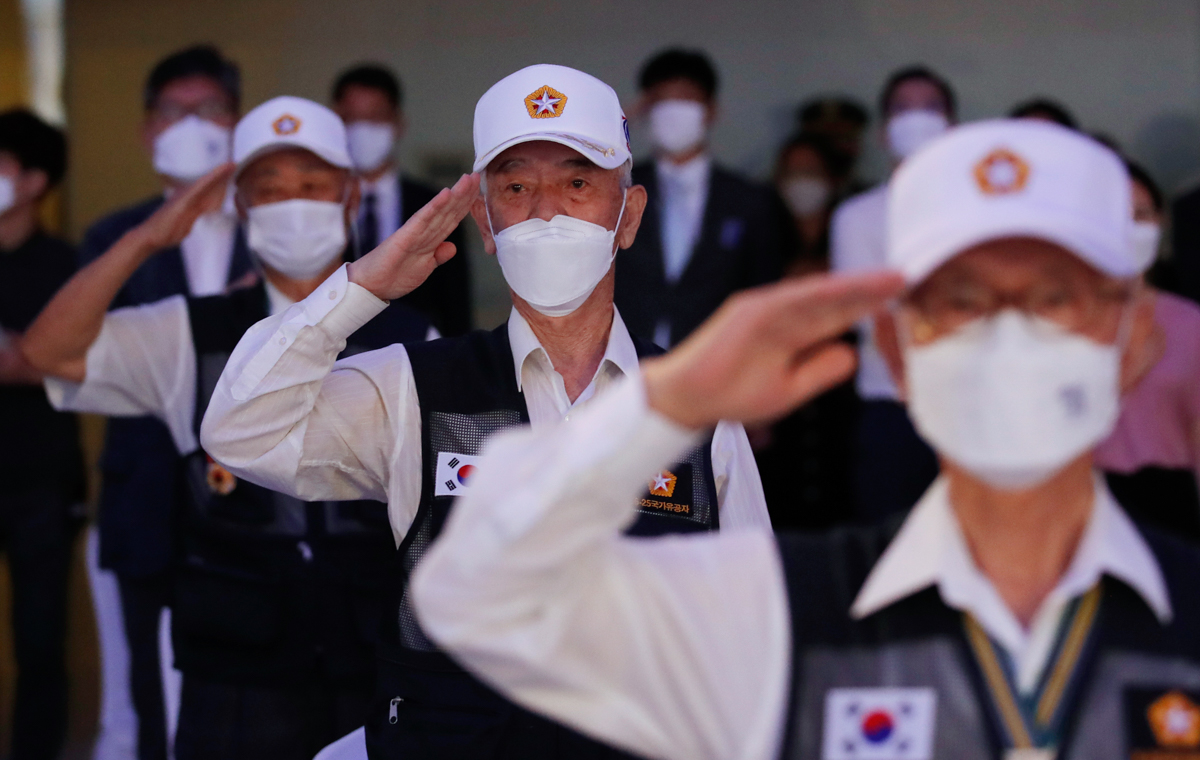 Korean War veterans salute during a commemorating ceremony for the U.N. Forces Participating Day in Seoul, South Korea, Monday, July 27, 2020. The day was to honor members of the U.N. forces who fough