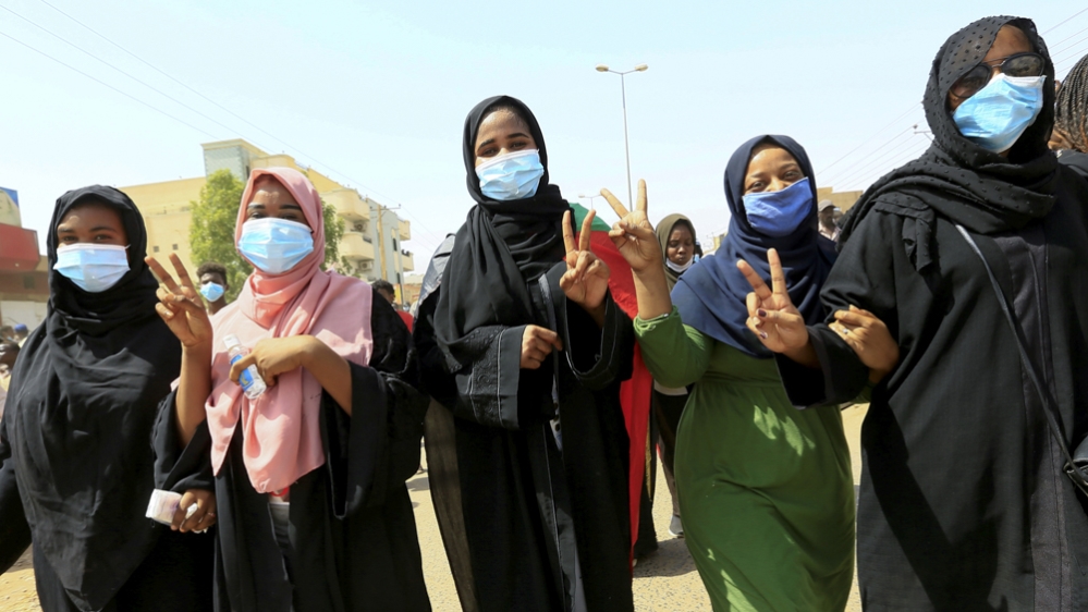 Civilians chant slogans as members of Sudanese pro-democracy protest on the anniversary of a major anti-military protest, as groups loyal to toppled leader Omar al-Bashir plan rival demonstrations in 