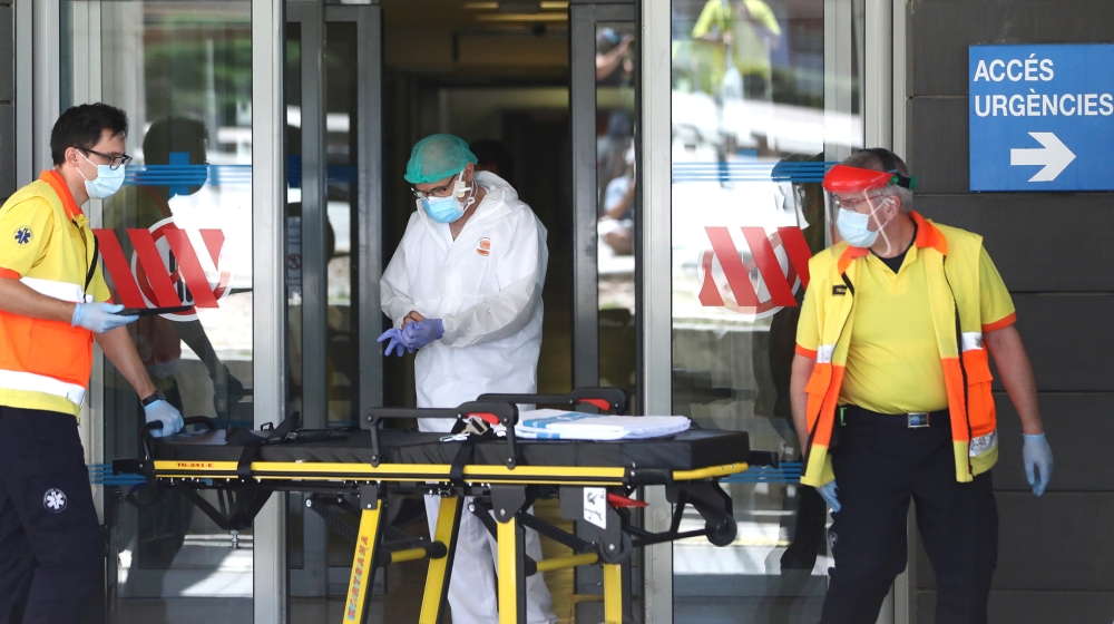 Health workers are seen at the emergencies entrance of Arnau de Vilanova hospital, after Catalonia''s government imposed new restrictions in an effort to control a new outbreak of the coronavirus disea
