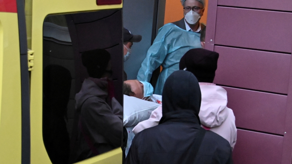 An ambulance transporting Russian opposition leader Alexei Navalny drives out of a hospital in Omsk