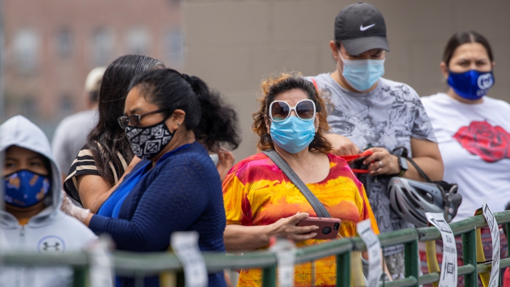 Customers wait in line to shop for food at a Food 4 Less grocery store, during the outbreak of the coronavirus disease (COVID-19), in Los Angeles