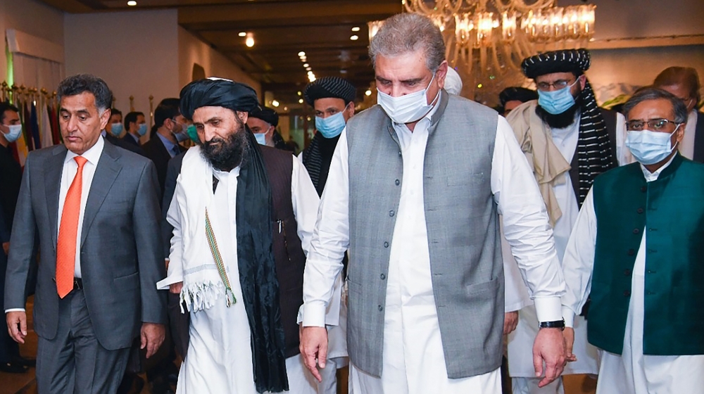 In this handout photograph taken on August 25, 2020, and released by the Pakistan Foreign Ministry, Pakistan''s Foreign Minister Shah Mehmood Qureshi (3R) walks with Taliban co-founder Mullah Abdul Gha