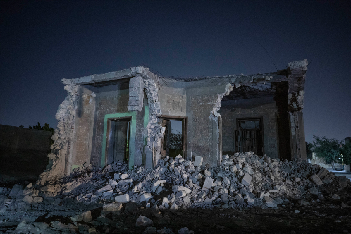 A building stands partially demolished after bulldozers cleared the way for construction of a multilane freeway through the Northern Cemetery, part of the historic City of the Dead, a UNESCO World Her