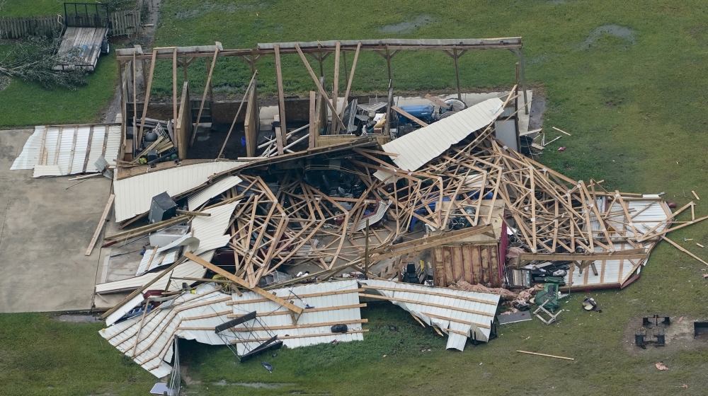Debris surrounds a damaged home in the aftermath of Hurricane Laura Thursday, Aug. 27, 2020, near Lake Charles, La. (AP Photo/David J. Phillip)