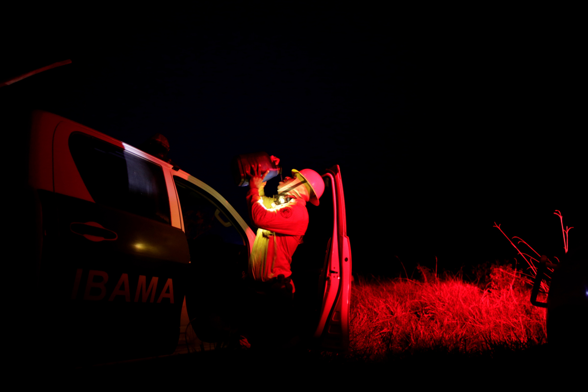 A Brazilian Institute for the Environment and Renewable Natural Resources (IBAMA) fire brigade member drinks water after attempting to control a fire in a tract of the Amazon jungle near Apui, Amazona