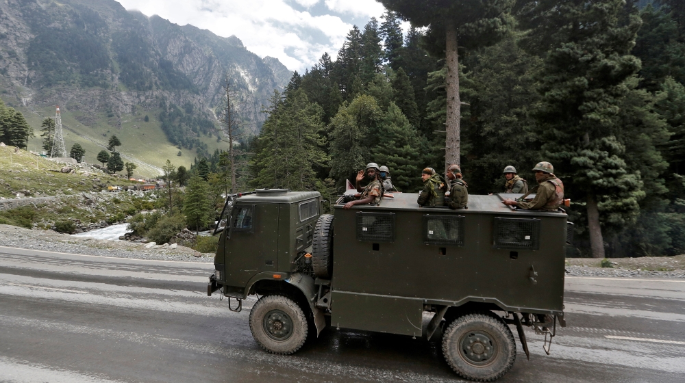 Indian army soldiers are seen atop a vehicle on a highway leading to Ladakh, at Gagangeer in Kashmir's Ganderbal district September 2, 2020. REUTERS/Danish Ismail