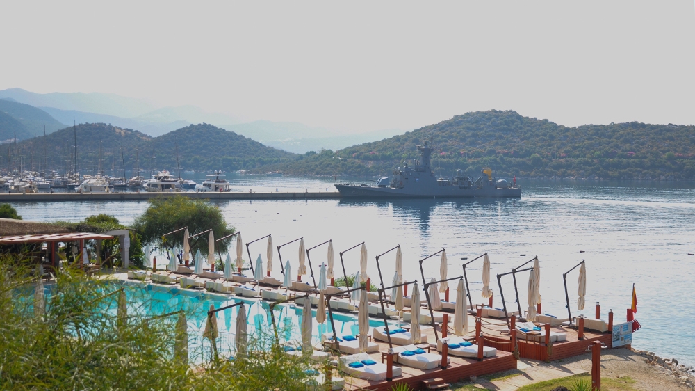 Warship by marina and beach club [Samuel Kent/Al Jazeera]