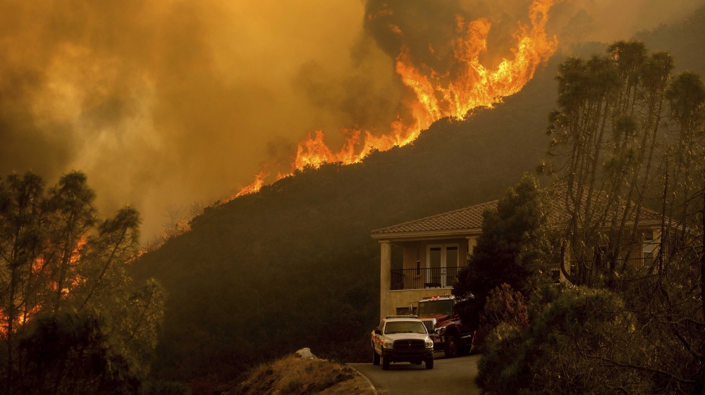 In this Monday, Aug. 17, 2020 file photo, flames from the River Fire crest a ridge in Salinas, Calif.