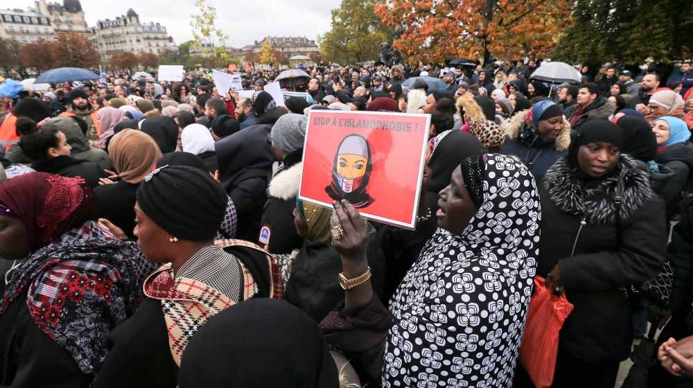 A woman holds a placard reading « Stop to islamophobia » as she takes part in a gathering place de la Nation, one of the Paris major crossroad on October 27, 2019, to protest against Islamophobia and 