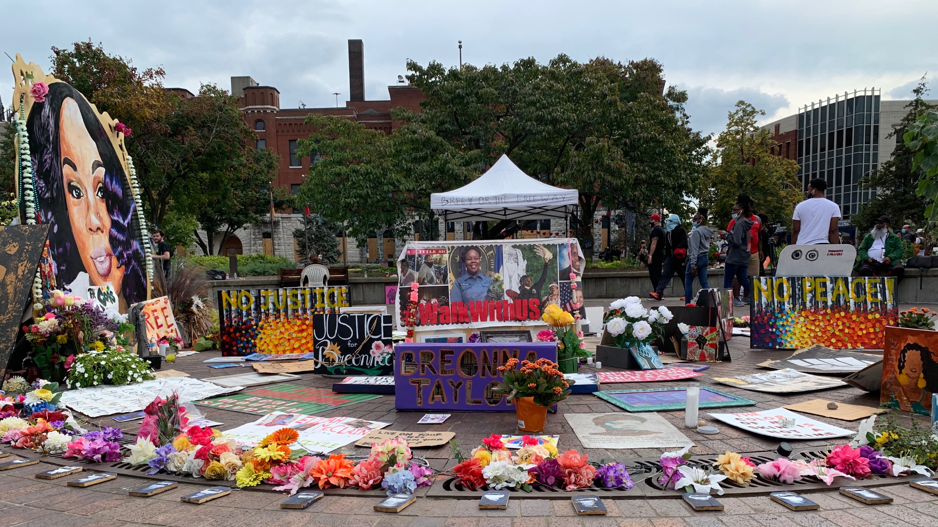 flowers and candles and photos of Breonna Taylor in Louisville