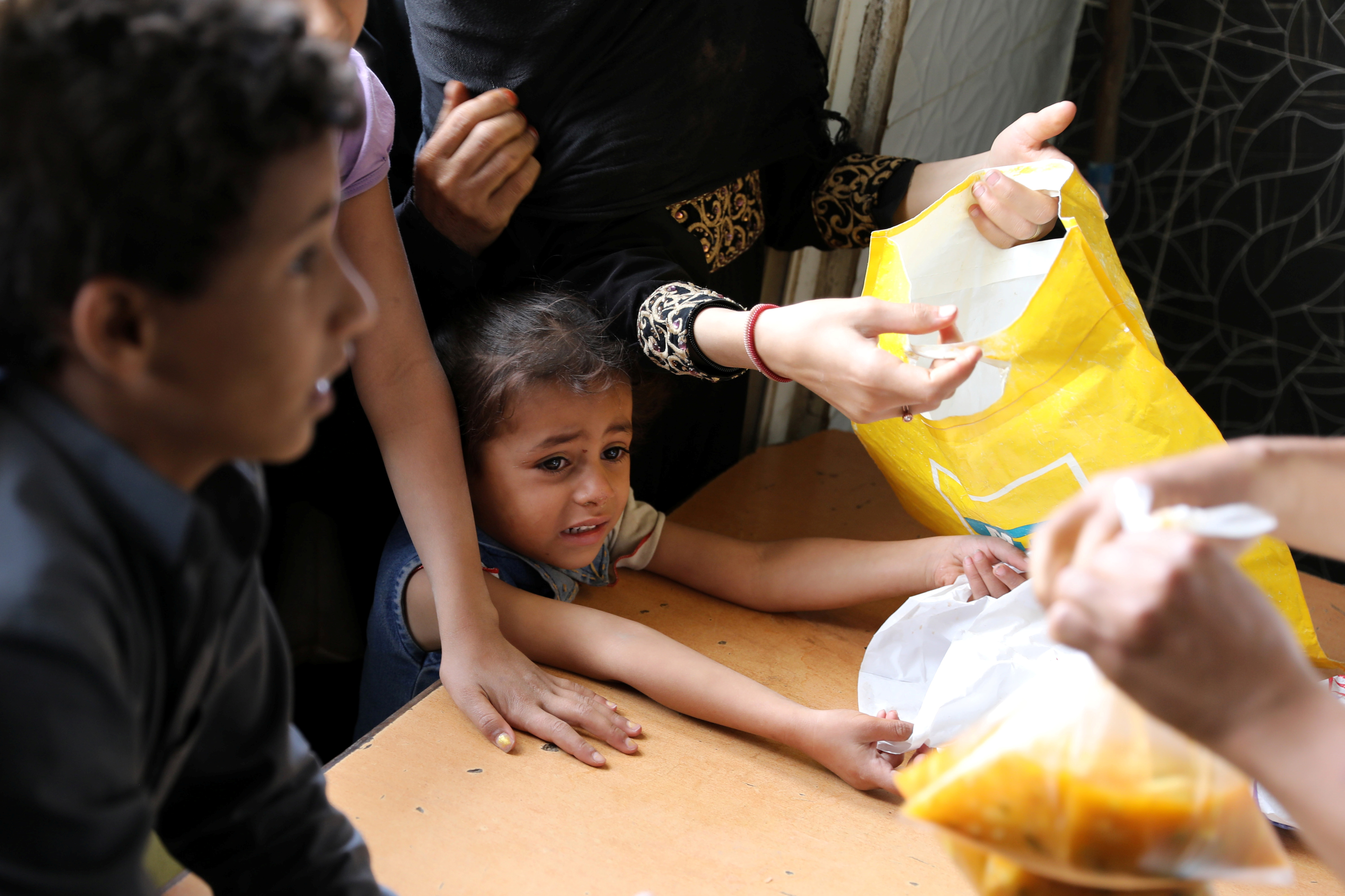 A girl pleads for a food ration at charity kitchen in Sanaa [File: Khaled Abdullah/Reuters]
