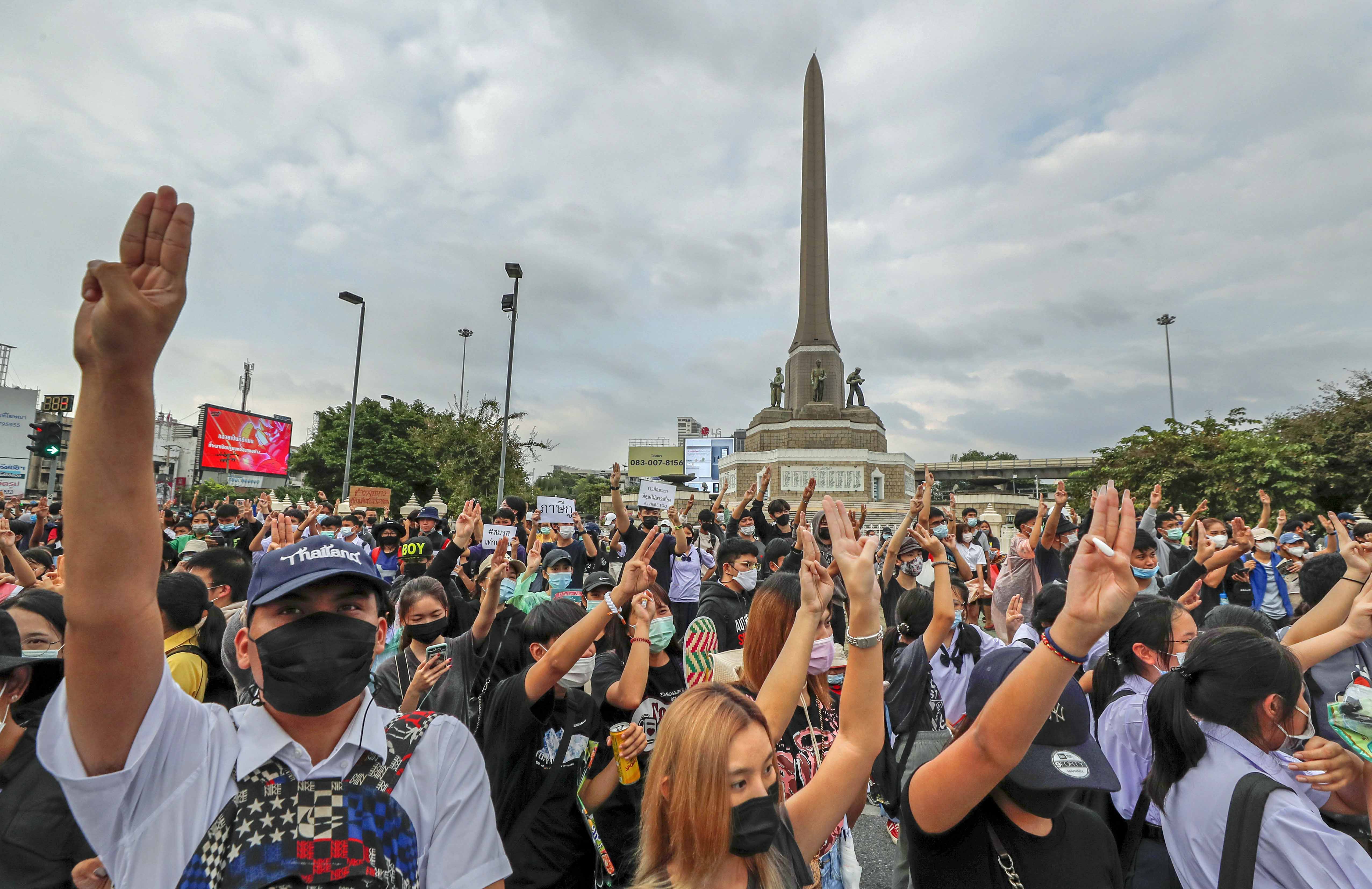 Thai pro-democracy activists flash the three-fingered salute during a demonstration at Victory Monument in Bangkok on October 21, 2020 [AP/Sakchai Lalit]