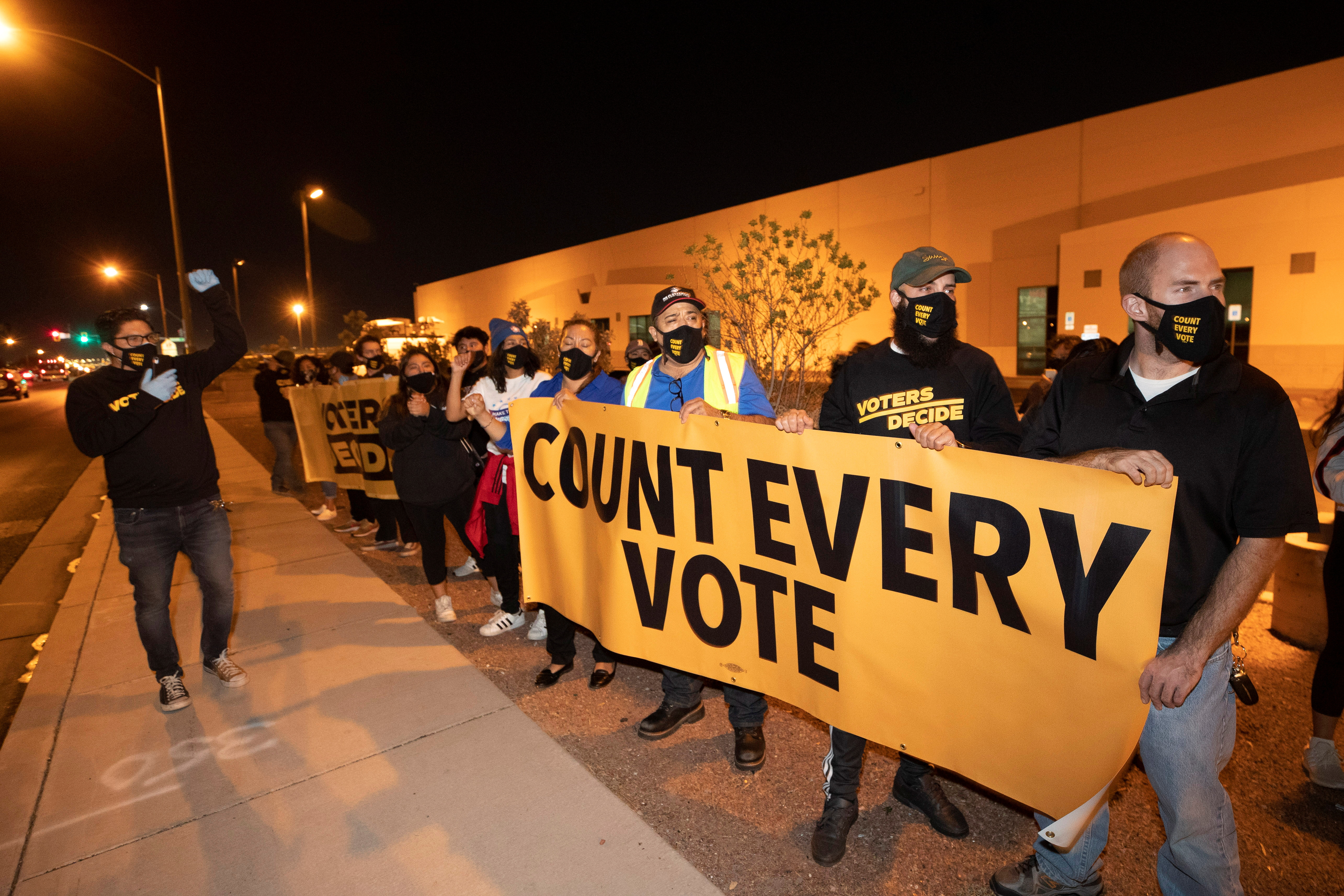Counter-protesters, organized by Make the Road Action Nevada and PLAN Action, chant during a "Stop the Steal" protest by supporters of U.S. President Donald Trump at the Clark County Election Center in North Las Vegas, Nevada,