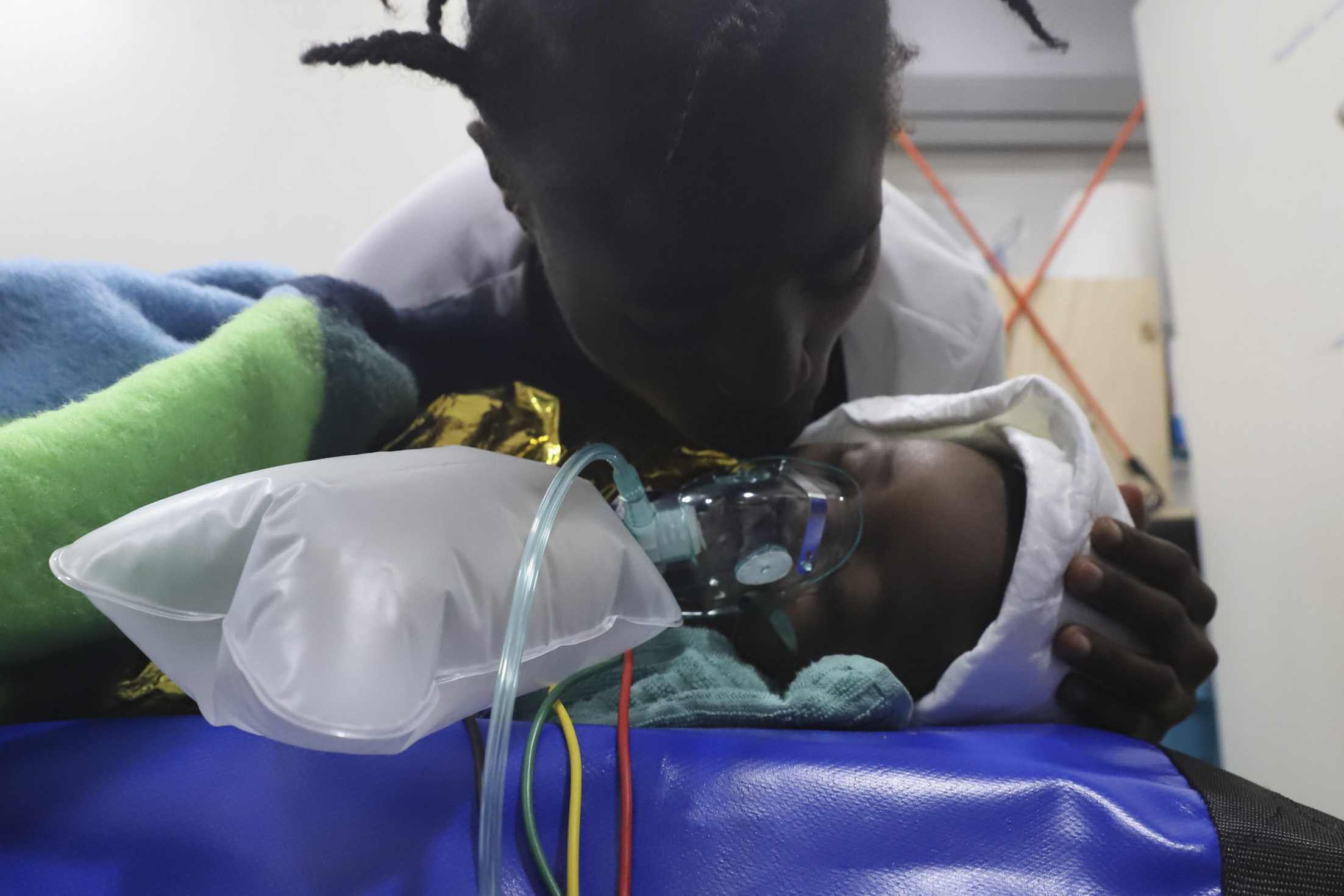 A refugee kisses her baby after they were rescued by NGO Proactiva Open Arms in the Mediterranean sea, on November 11, 2020