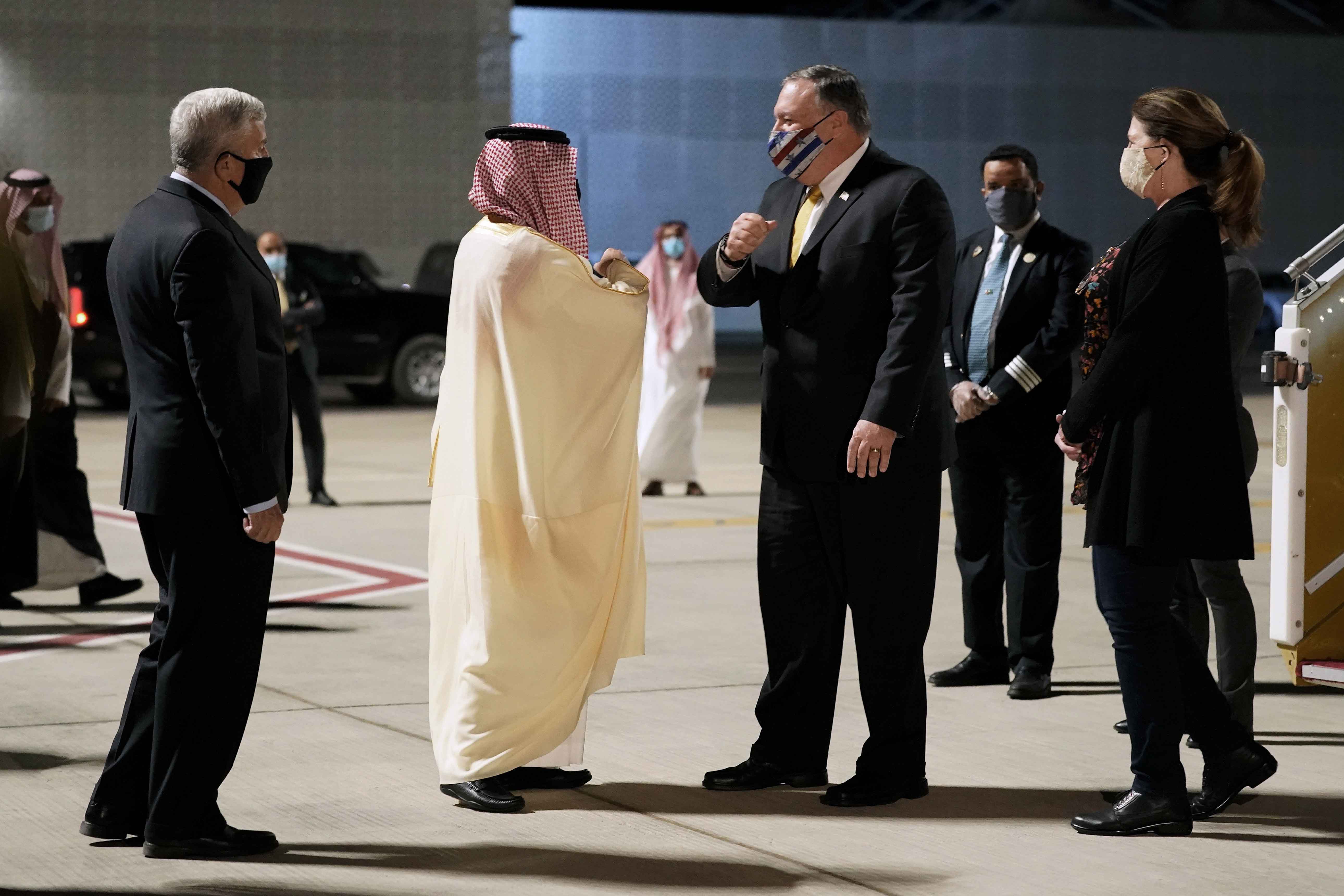 US Ambassador to Saudi Arabia John Abizaid and Saudi Arabia's Foreign Minister Faisal bin Farhan greet Secretary of State Mike Pompeo and his wife Susan as they arrive at Neom Bay Airport in Neom, Saudi Arabia on November 22, 2020 [AP/Patrick Semansky]