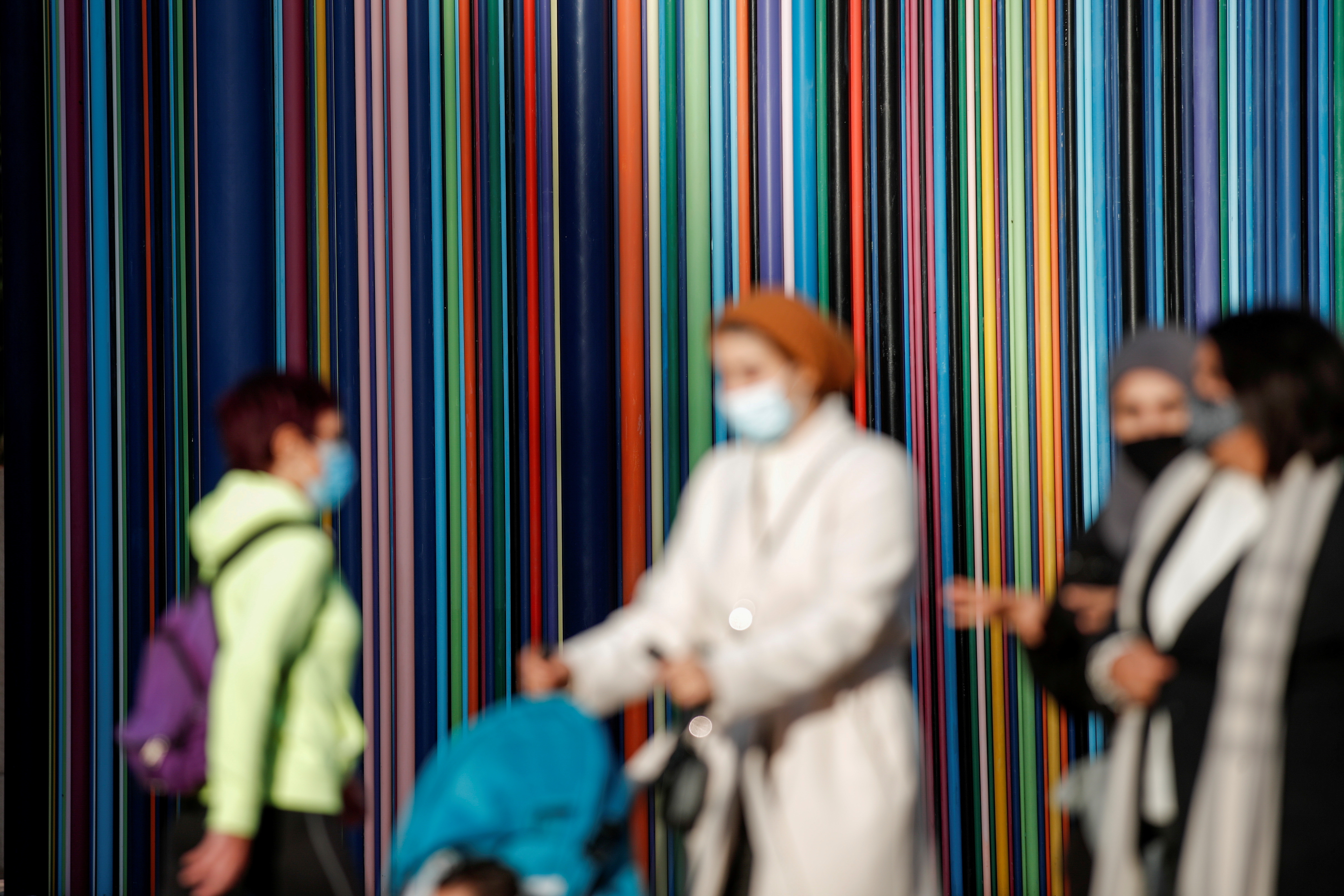 Women wearing protective face masks walk at the financial and business district of La Defense, amid the outbreak of the coronavirus disease (COVID-19), in Paris, France, November 9, 2020. [Benoit Tessier/Reuters]