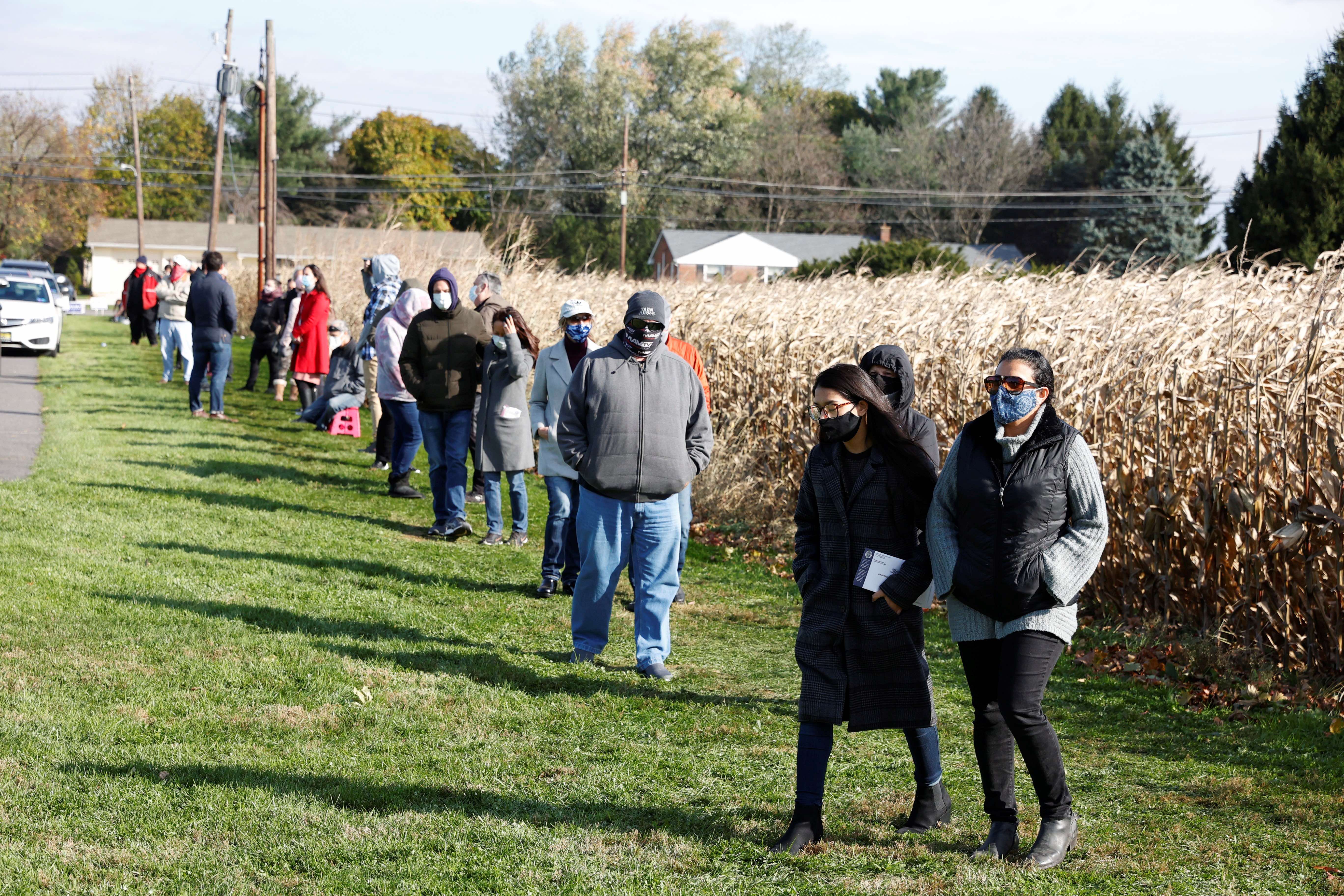 Voters line up to cast their ballots on election day near Dryland United Church of Christ in Lower Nazareth, Pennsylvania, United States [Rachel Wisniewski/Reuters]
