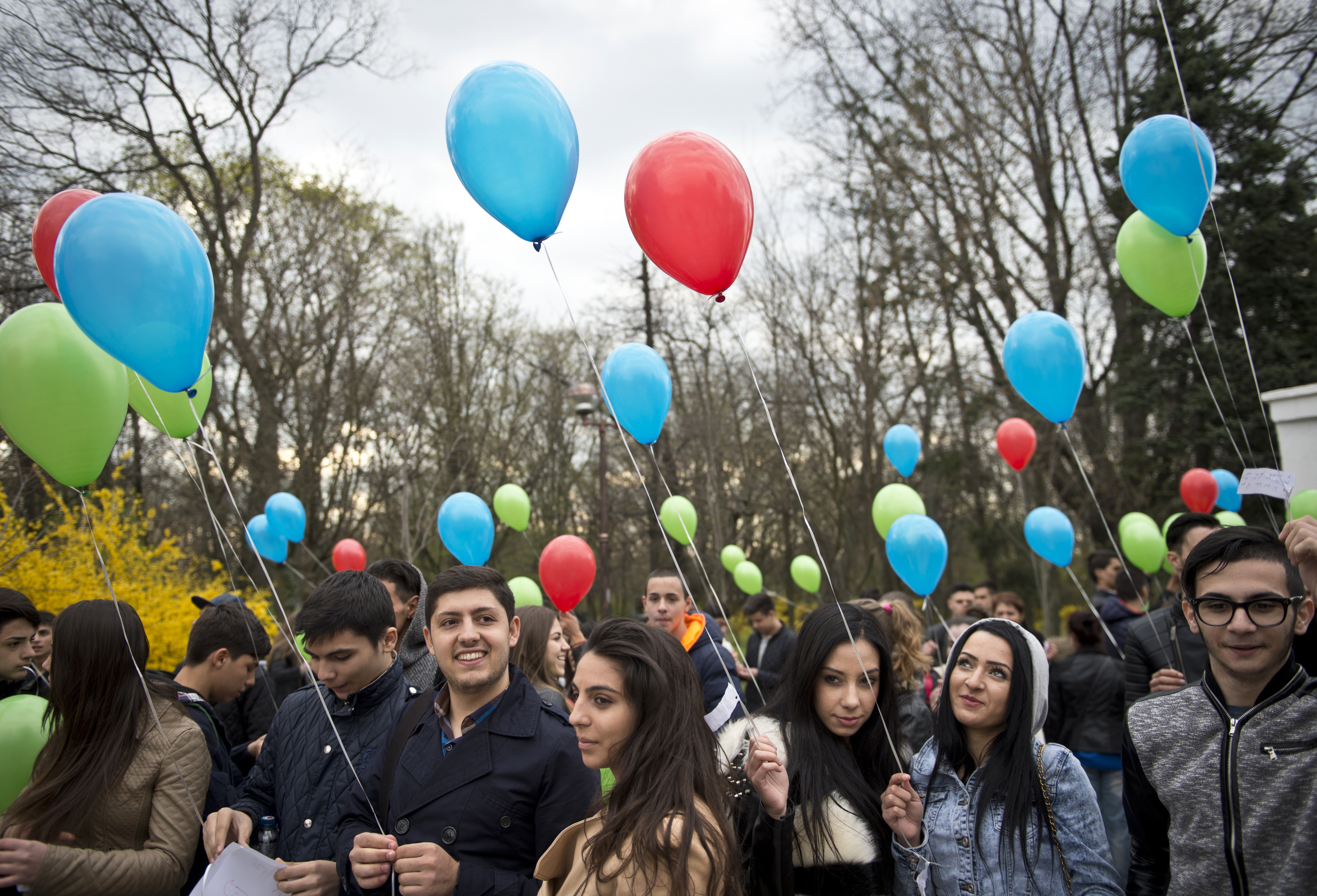 Romanian youths hold balloons with small notes to be lifted up during the International Romani Day at Herastrau Park in Bucharest on April 8, 2015 [File: AFP/Daniel Mihailescu]