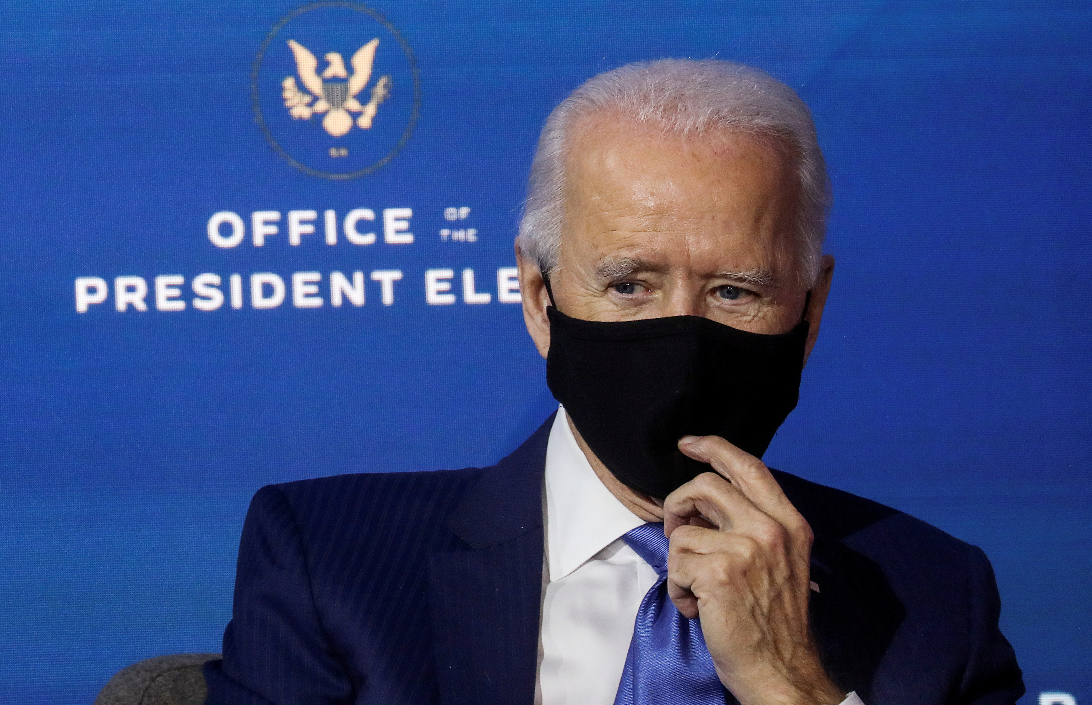 US President-elect Joe Biden listens after announcing nominees and appointees to serve on his economic policy team at his transition headquarters in Wilmington, Delaware