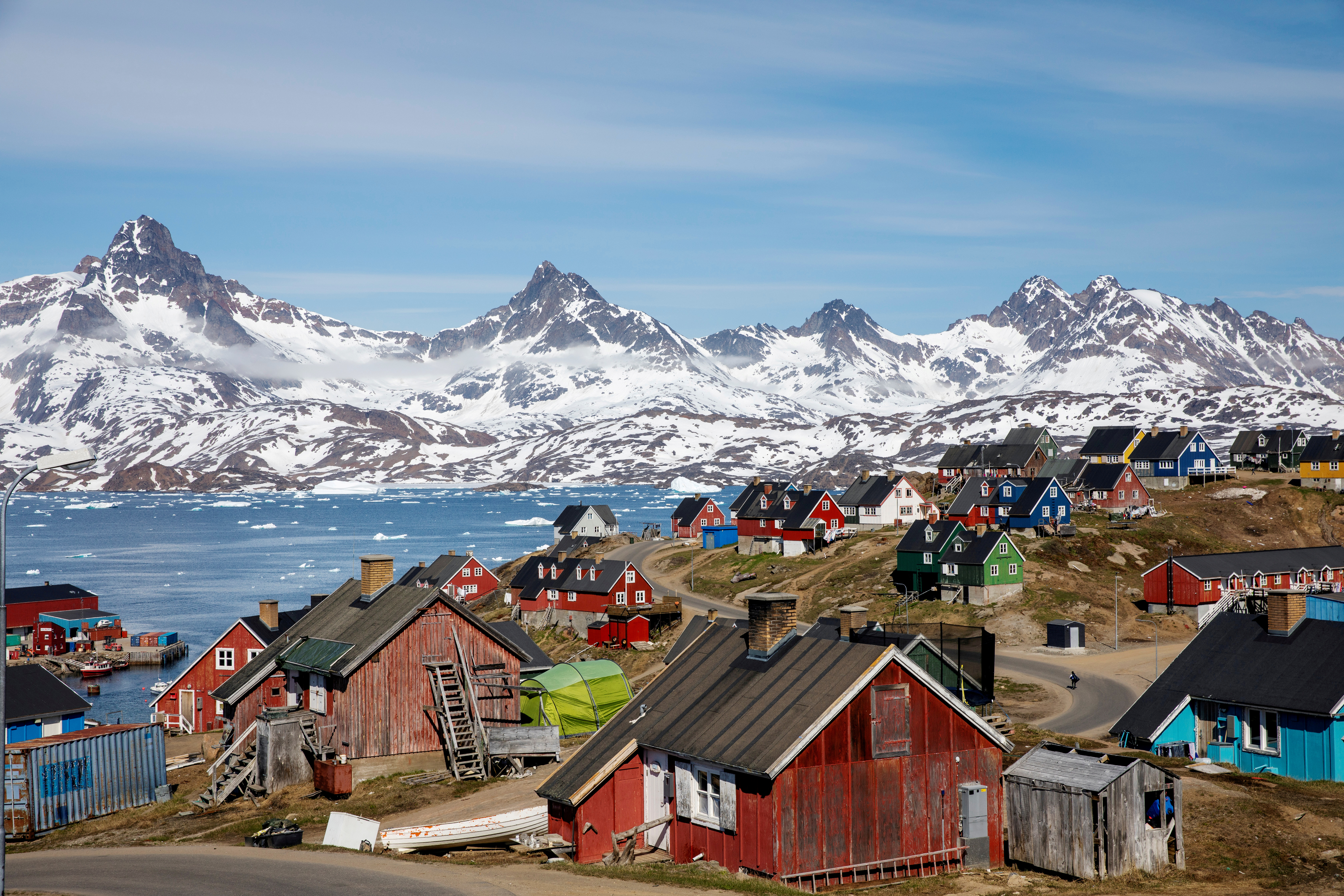 FILE PHOTO: Snow covered mountains rise above the harbour and town of Tasiilaq, Greenland, June 15, 2018. REUTERS/Lucas Jackson