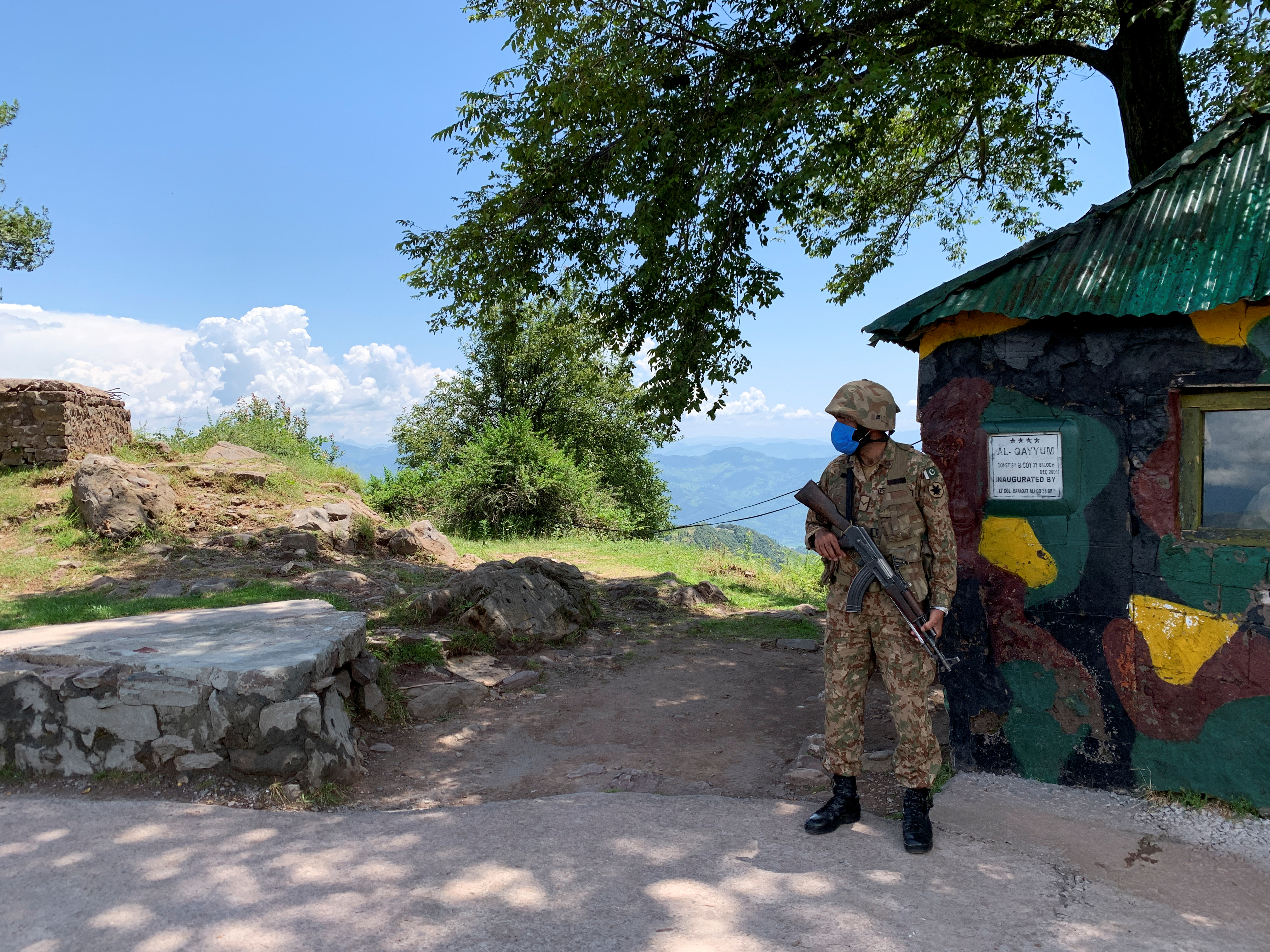 A Pakistani soldier stands guard at a hilltop post near the Line of Control that divides Kashmir between India and Pakistan [File: Charlotte Greenfield/Reuters]