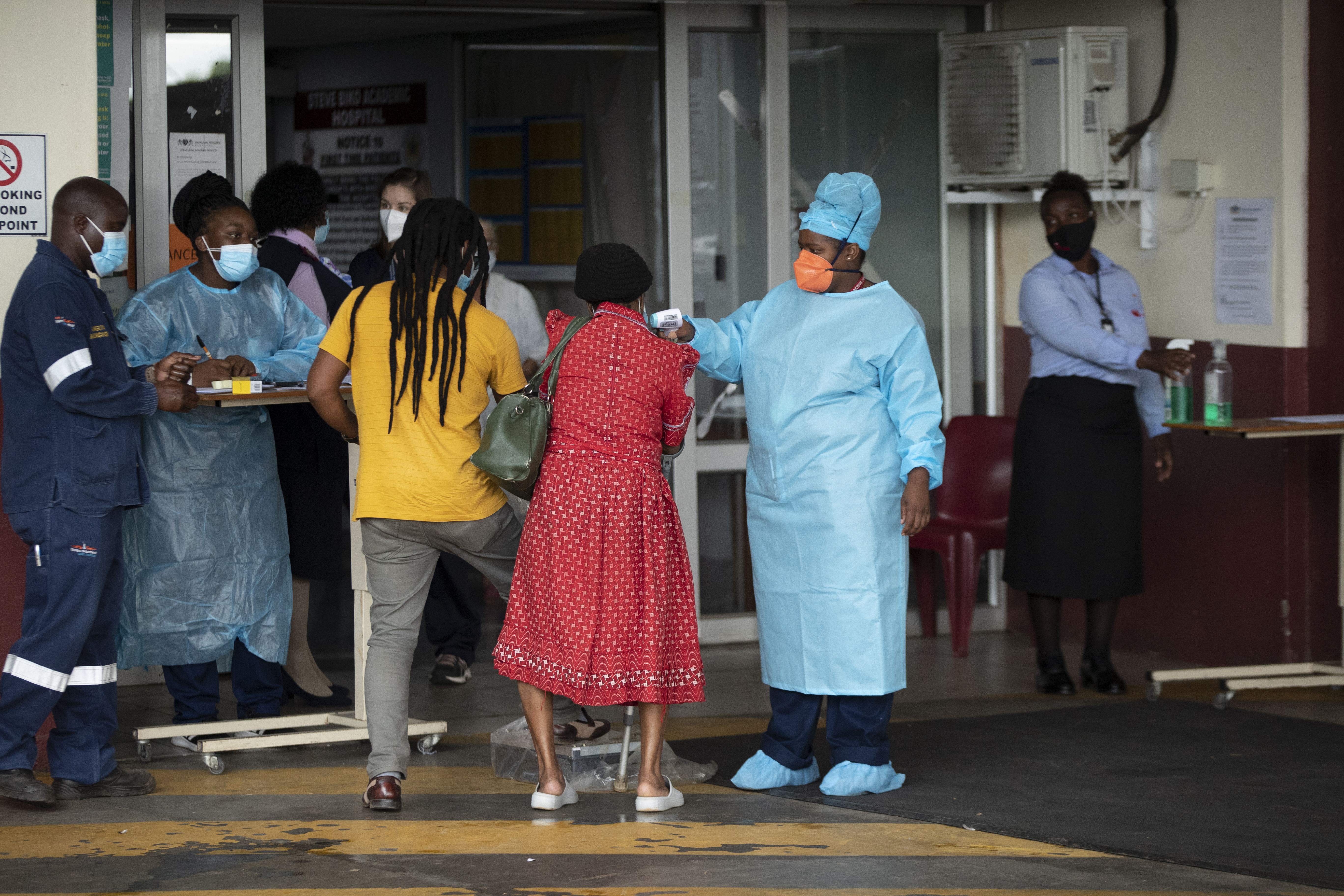 A health worker checks the temperature of an elderly patient at the emergency entrance of the Steve Biko Academic Hospital in Pretoria [File: Themba Hadebe/AP Photo]