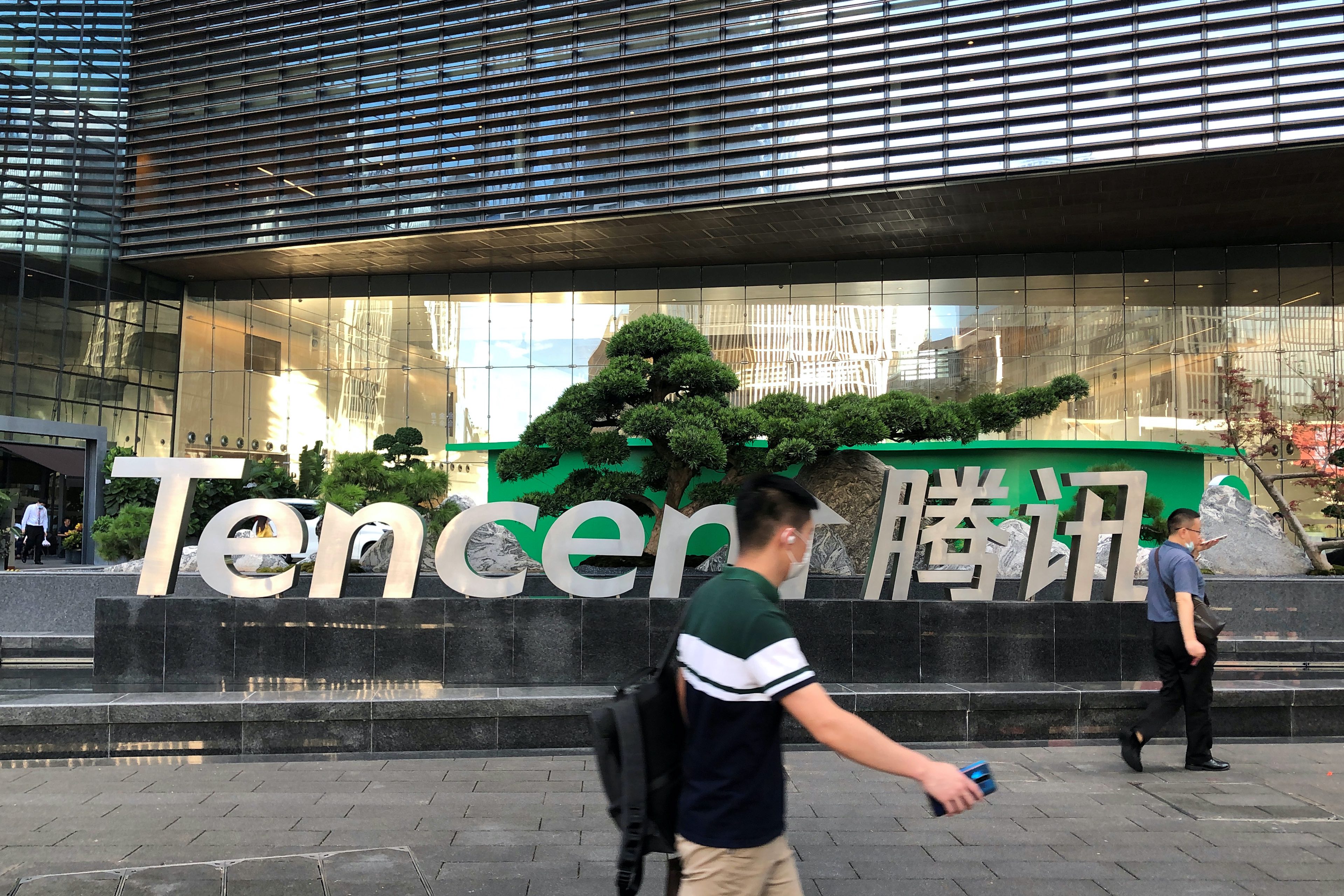 People walk past a Tencent sign at the company headquarters in Shenzhen, Guangdong Province, China