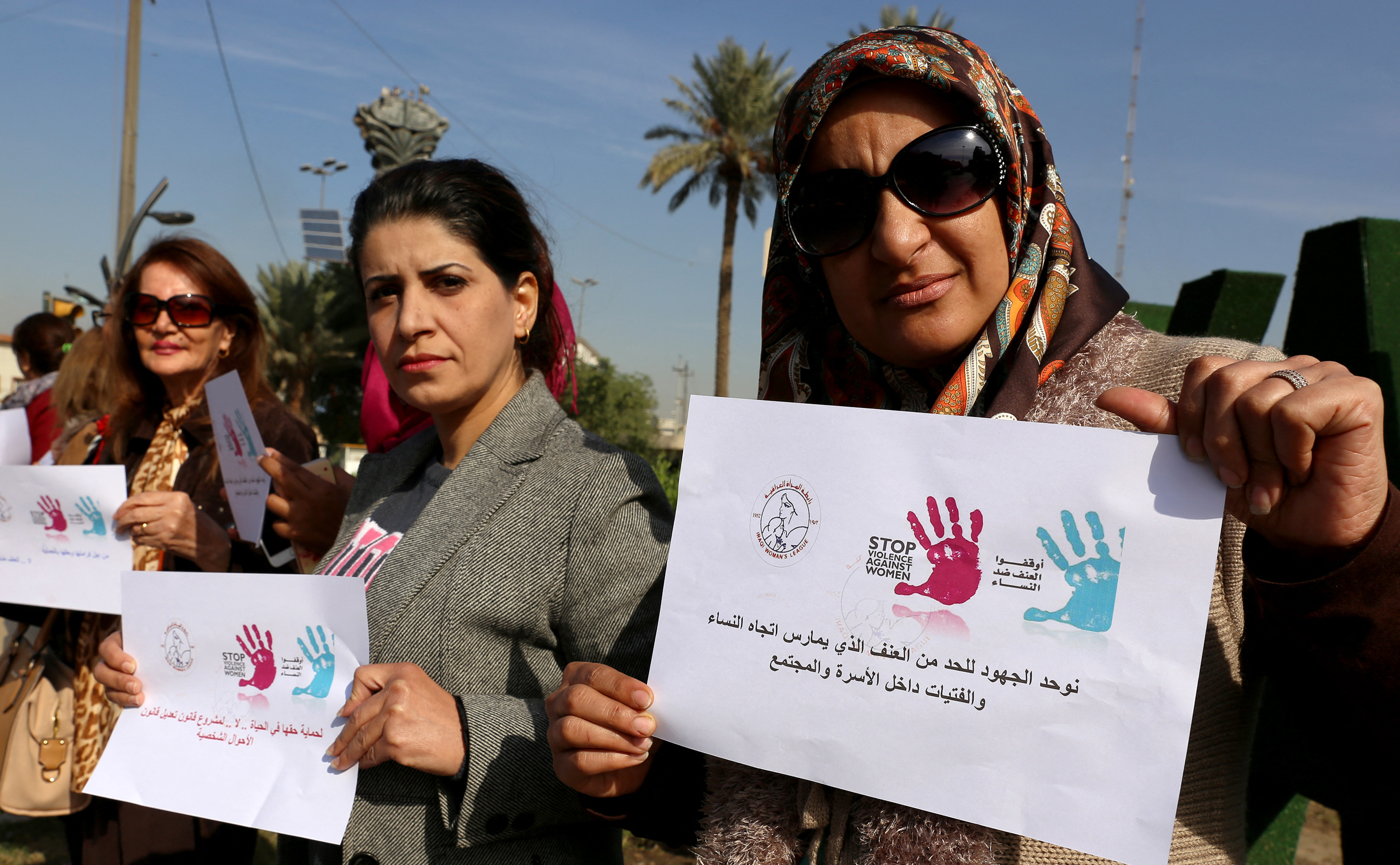 Iraqi women demonstrate at a vigil condemning violence against women