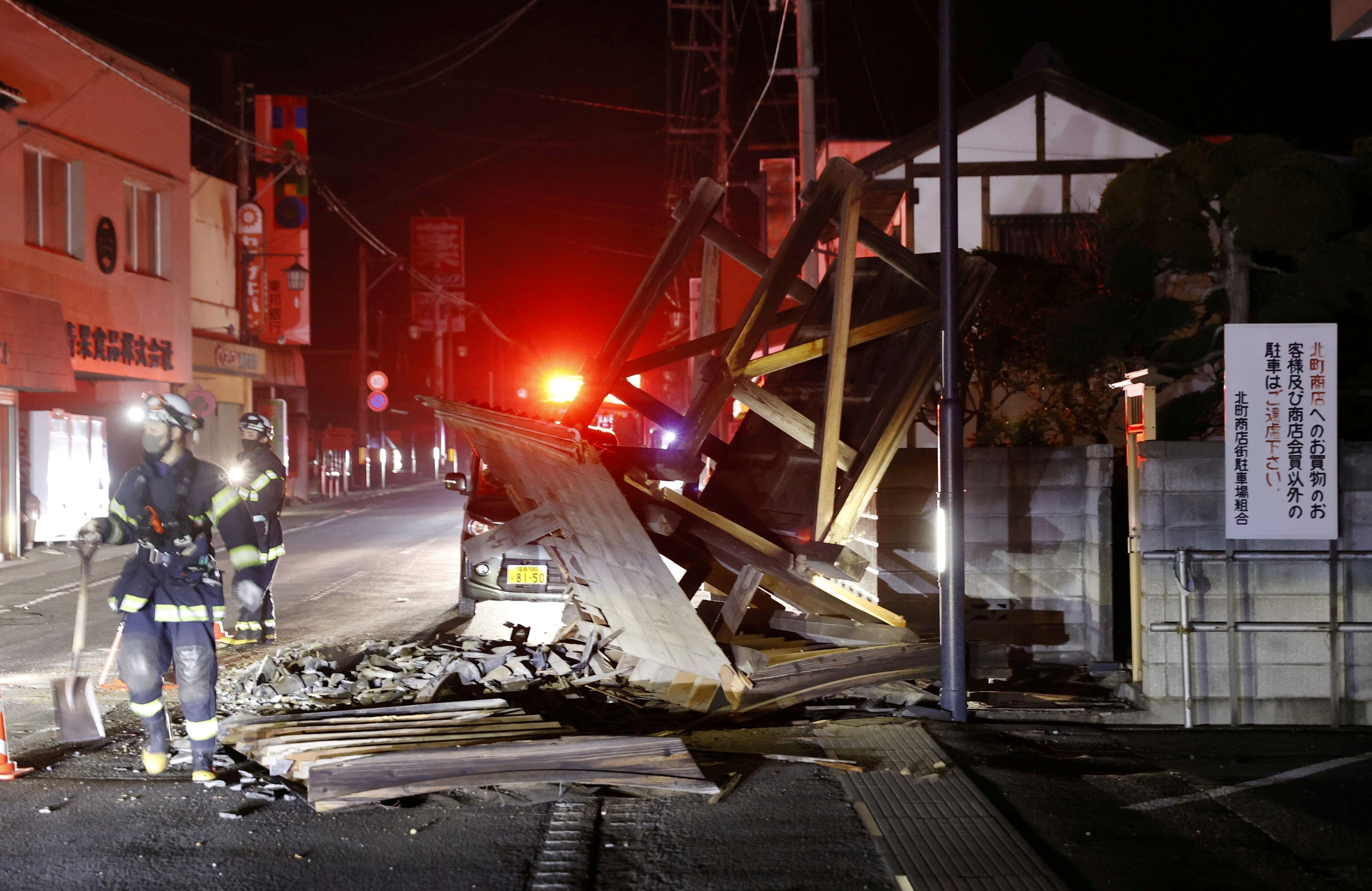 A gate is seen broken in Koori, Fukushima Prefecture, early on February 14, 2021, after a strong earthquake shook northeastern Japan