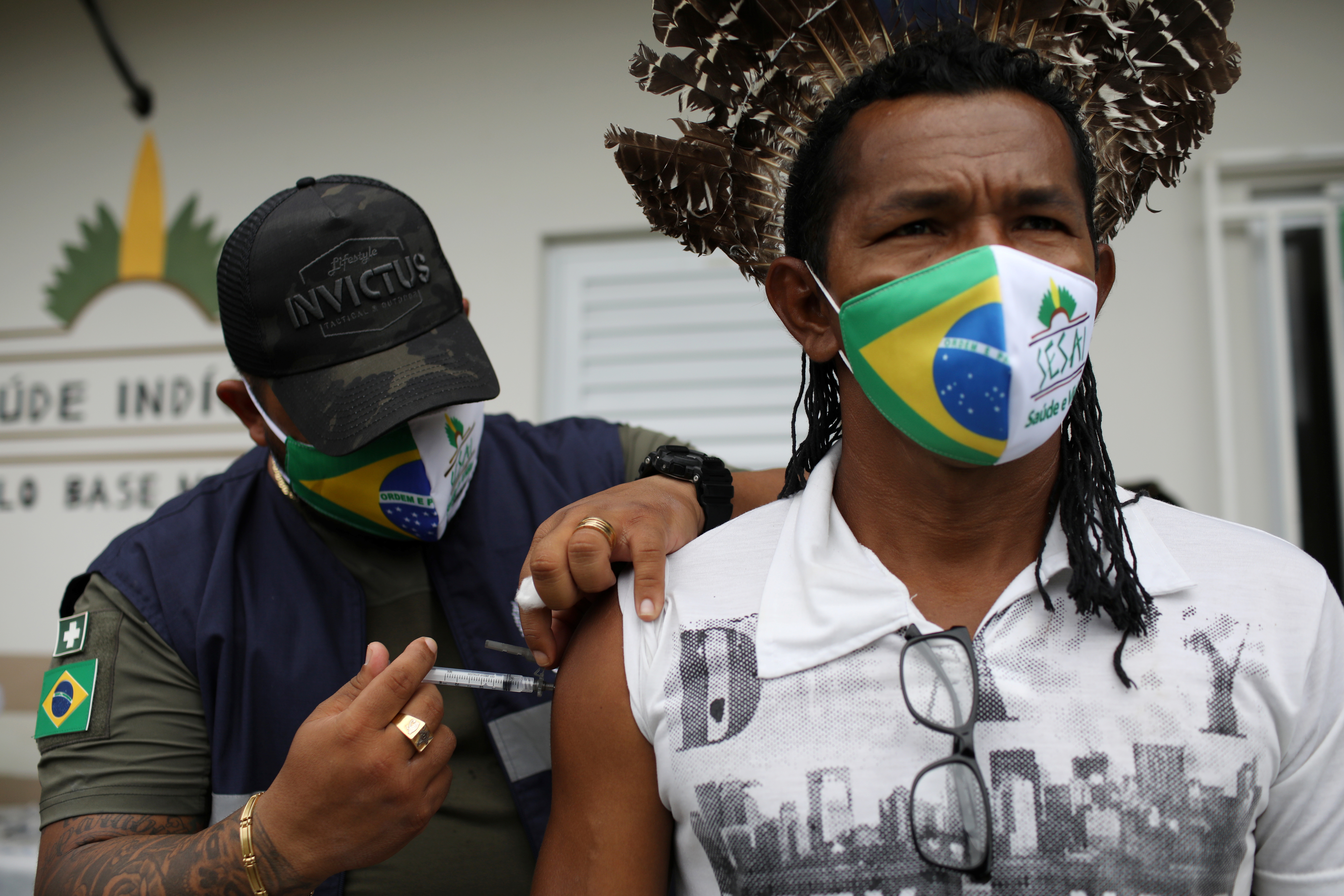 A health worker of the Indigenous Special Sanitary District of Manaus administers Sinovac’s CoronaVac vaccine to a man of Mura ethnicity at Makira village in the Rio Urubu community in Itacoatiara, Amazonas state