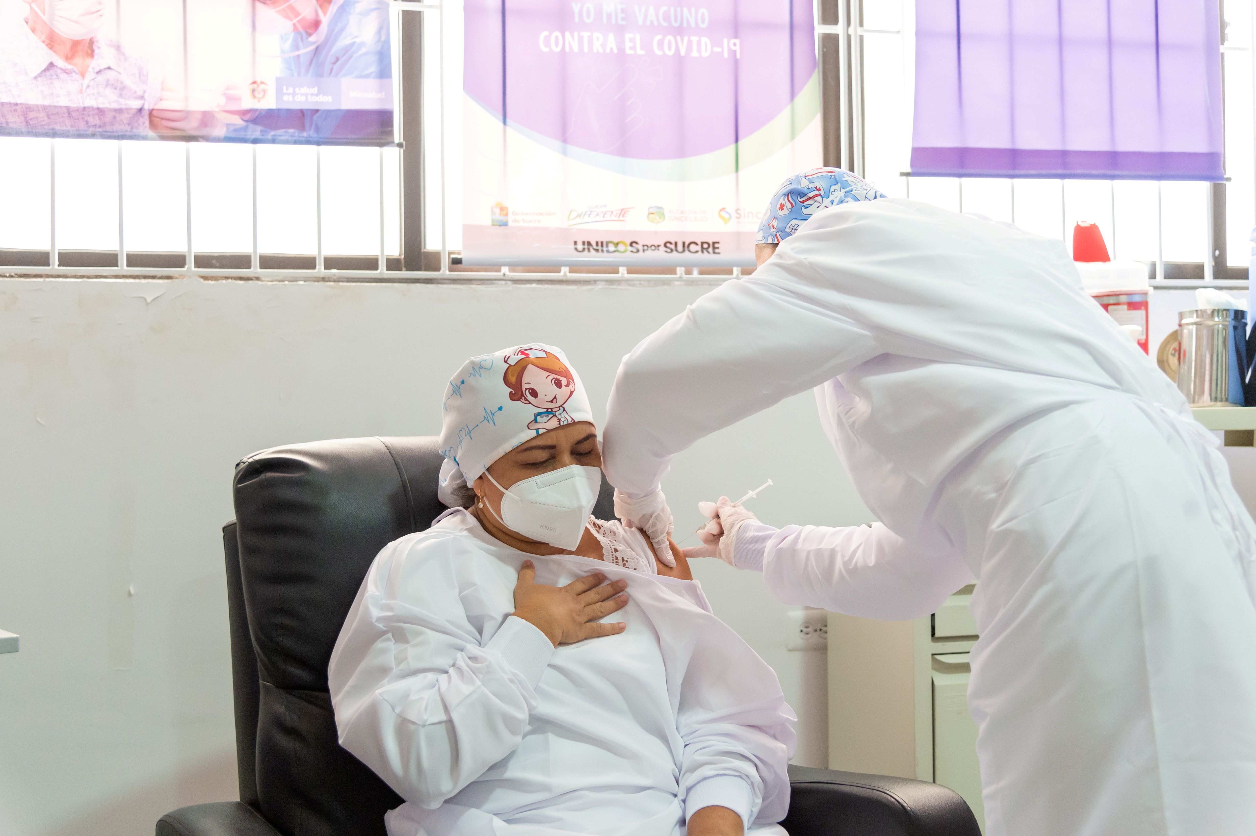 Veronica Machado, 46, head nurse of the Hospital Universitario de Sincelejo receiving a dose of the Pfizer/BioNTech vaccine [Colombian Presidency via Reuters]
