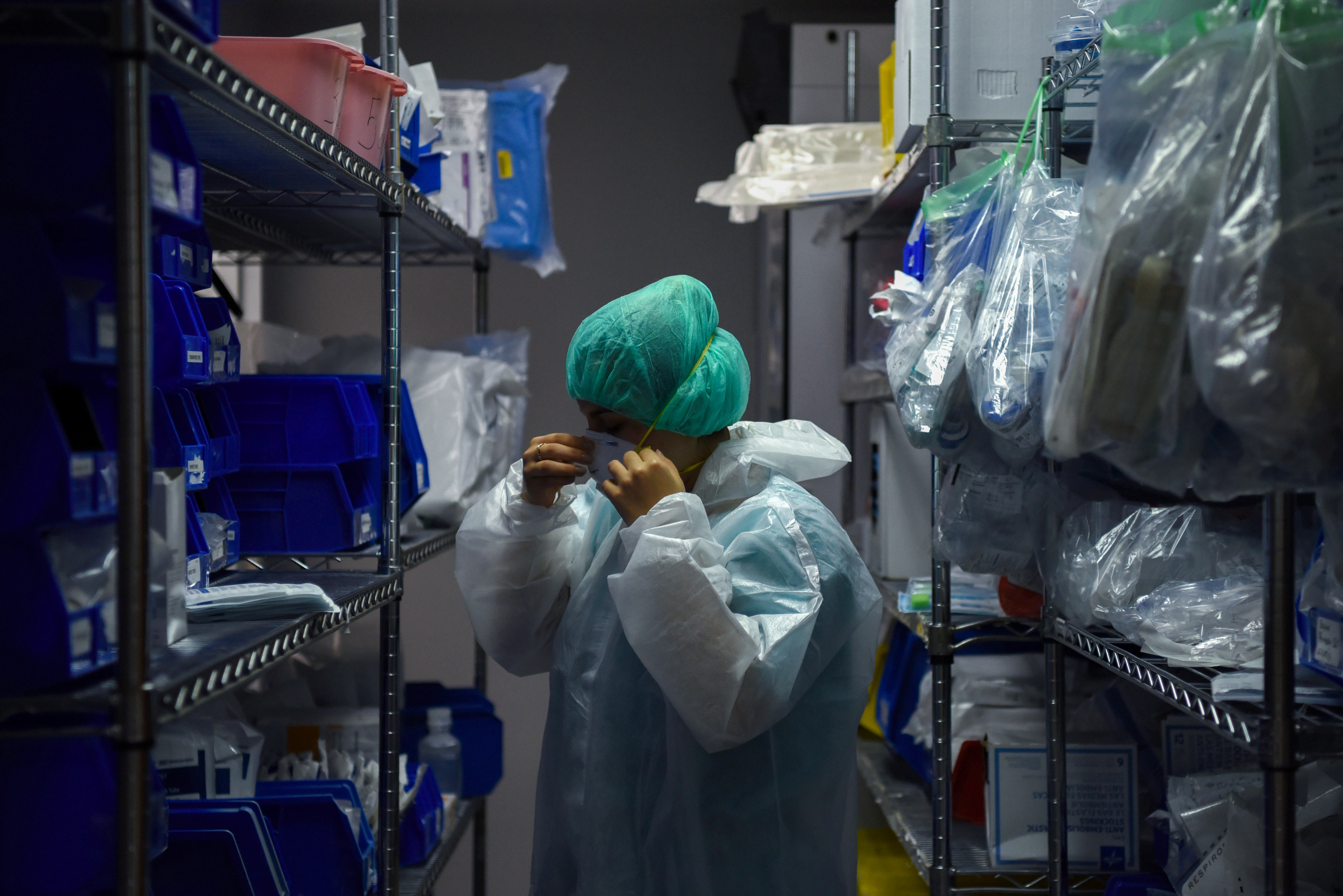 A medical worker puts on personal protective equipment at the United Memorial Medical Center’s coronavirus intensive care unit in Houston, Texas, US [File: Callaghan O'Hare/Reuters]