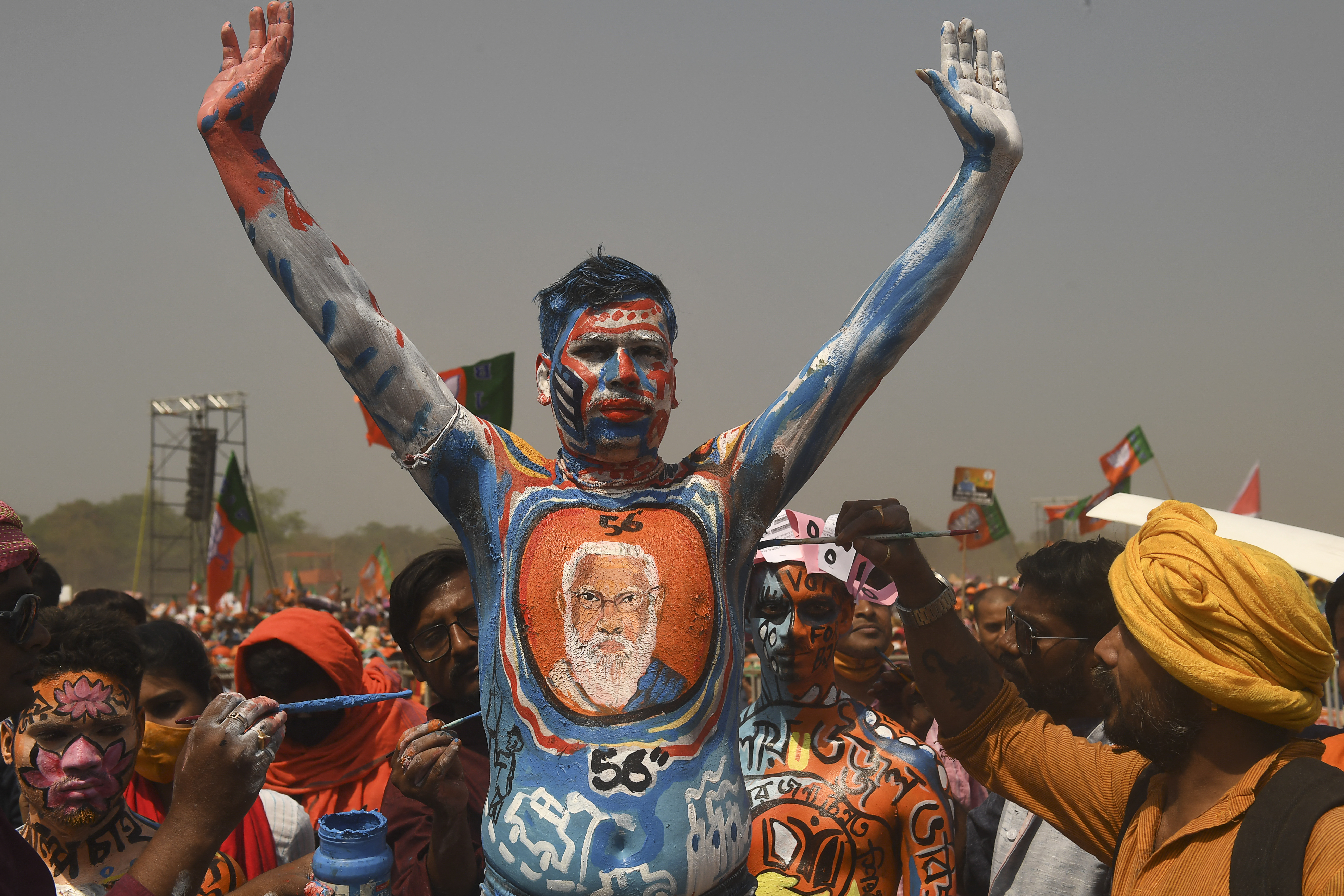 A BJP supporter with his body painted gestures during an election rally addressed by India's Prime Minister Narendra Modi in Kolkata [Dibyangshu Sarkar/AFP]